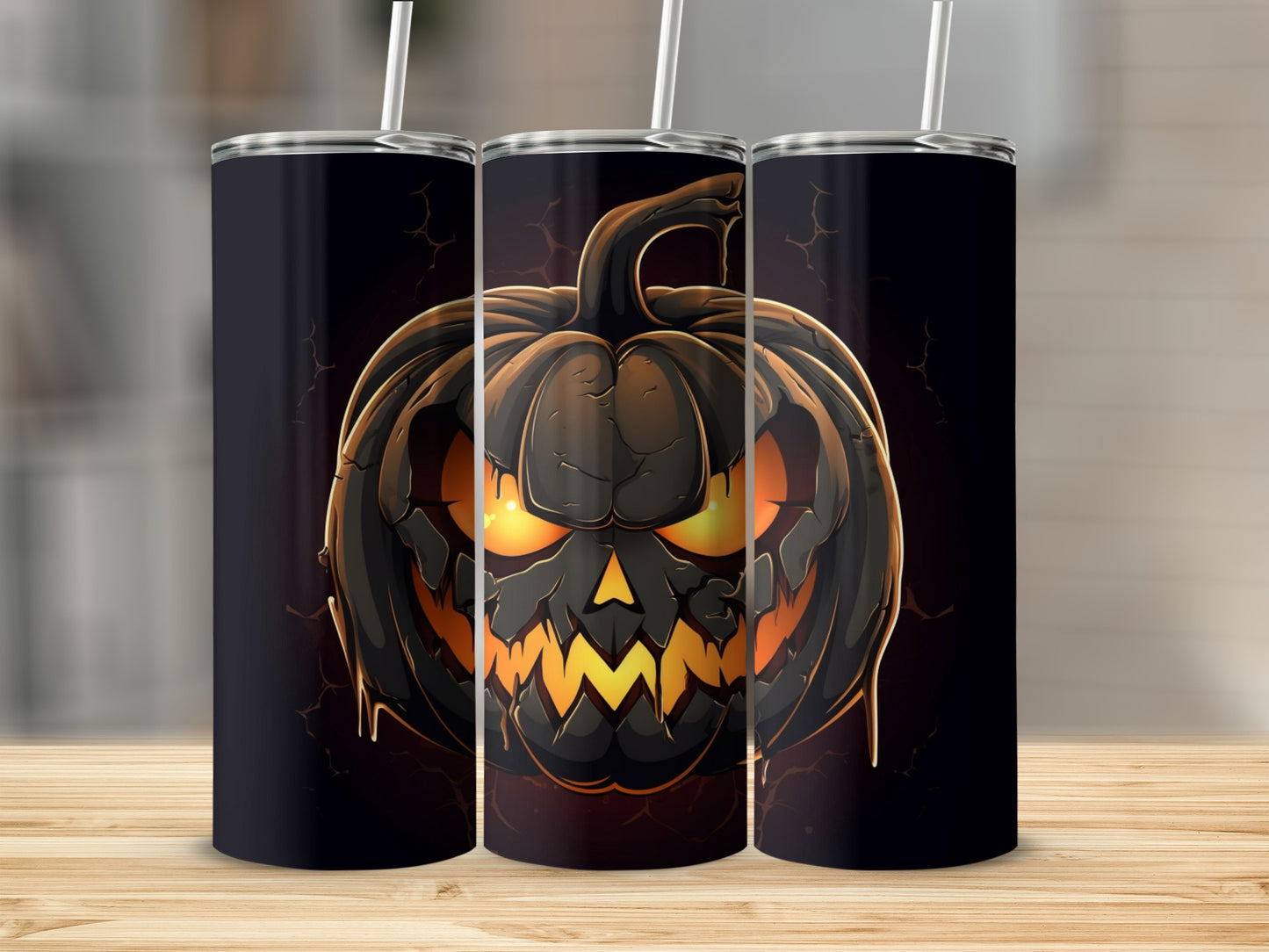 Three tumblers with a spooky black jack-o'-lantern design and glowing orange eyes.