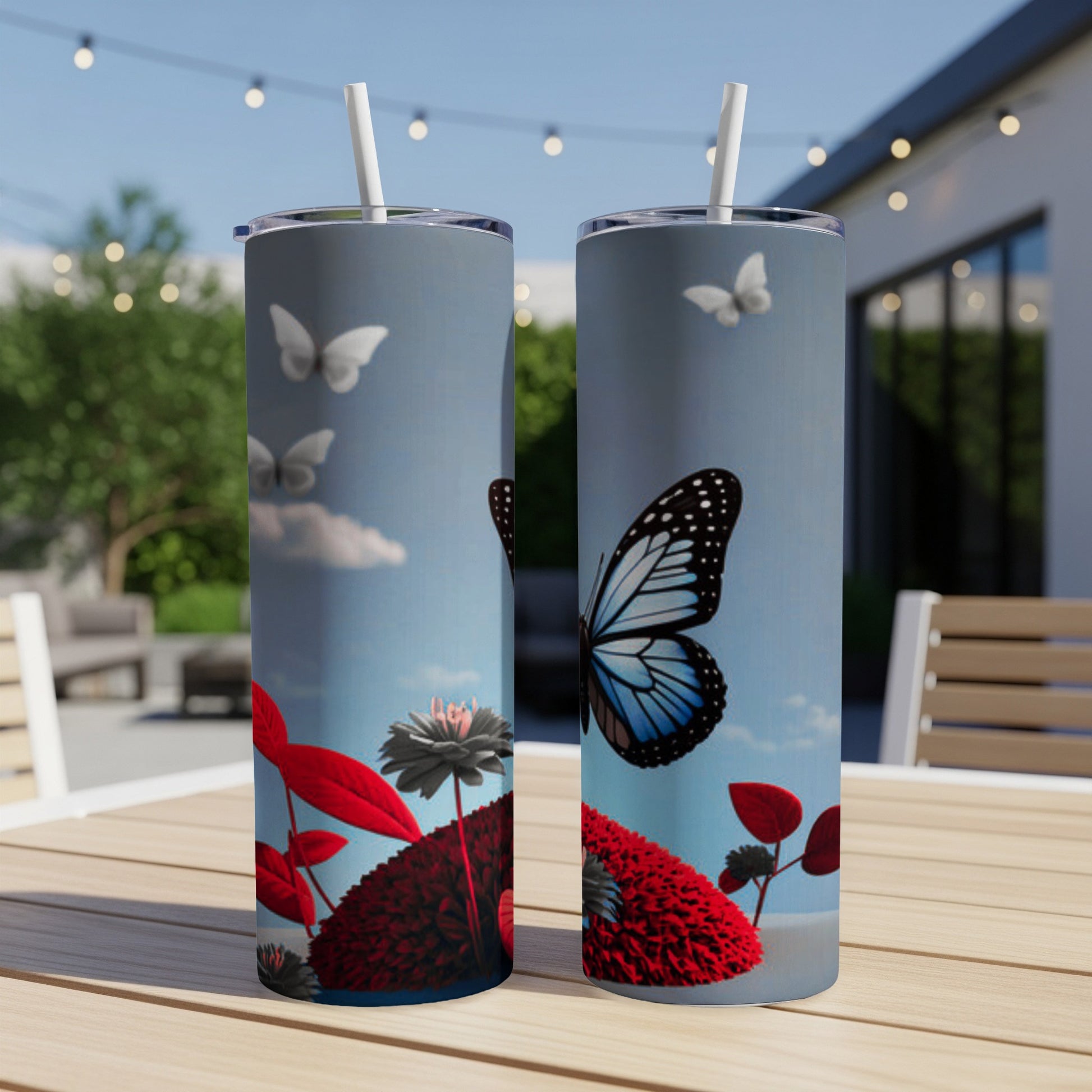 Two tumblers with butterflies and red flowers against a sky background.