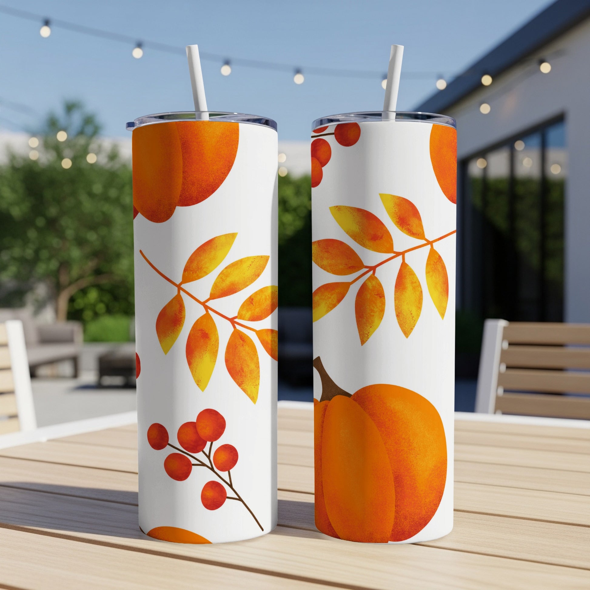 Two white tumblers with a fall pattern of pumpkins and berries.