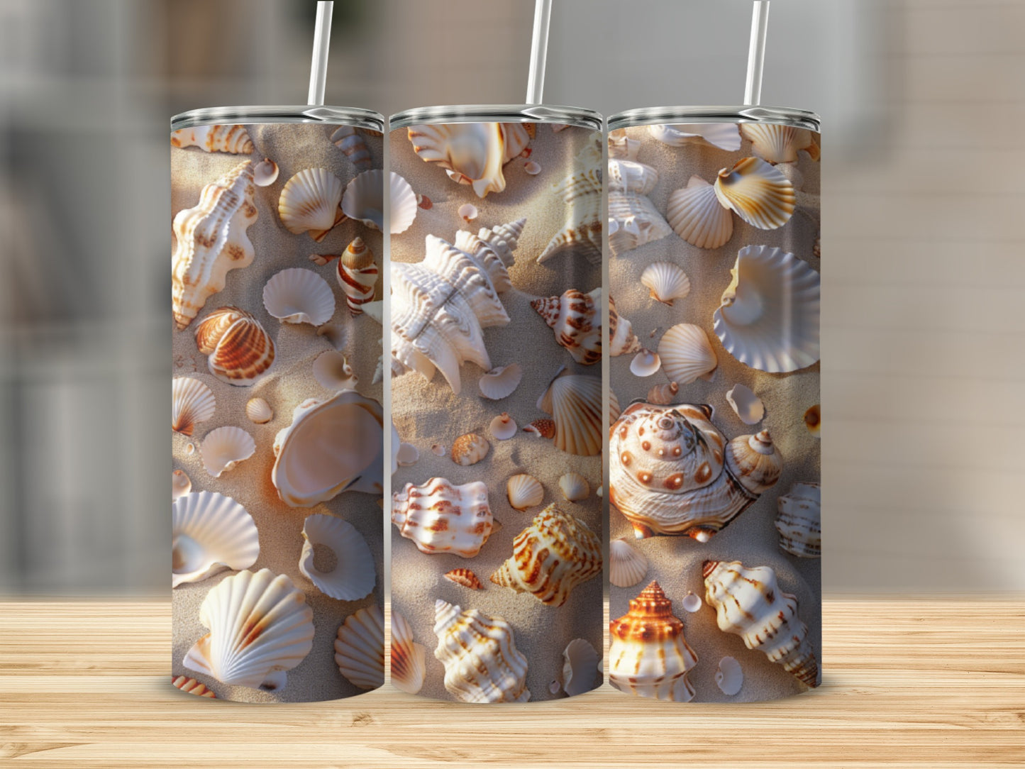 Three tumblers adorned with scattered seashells on a sandy beach.