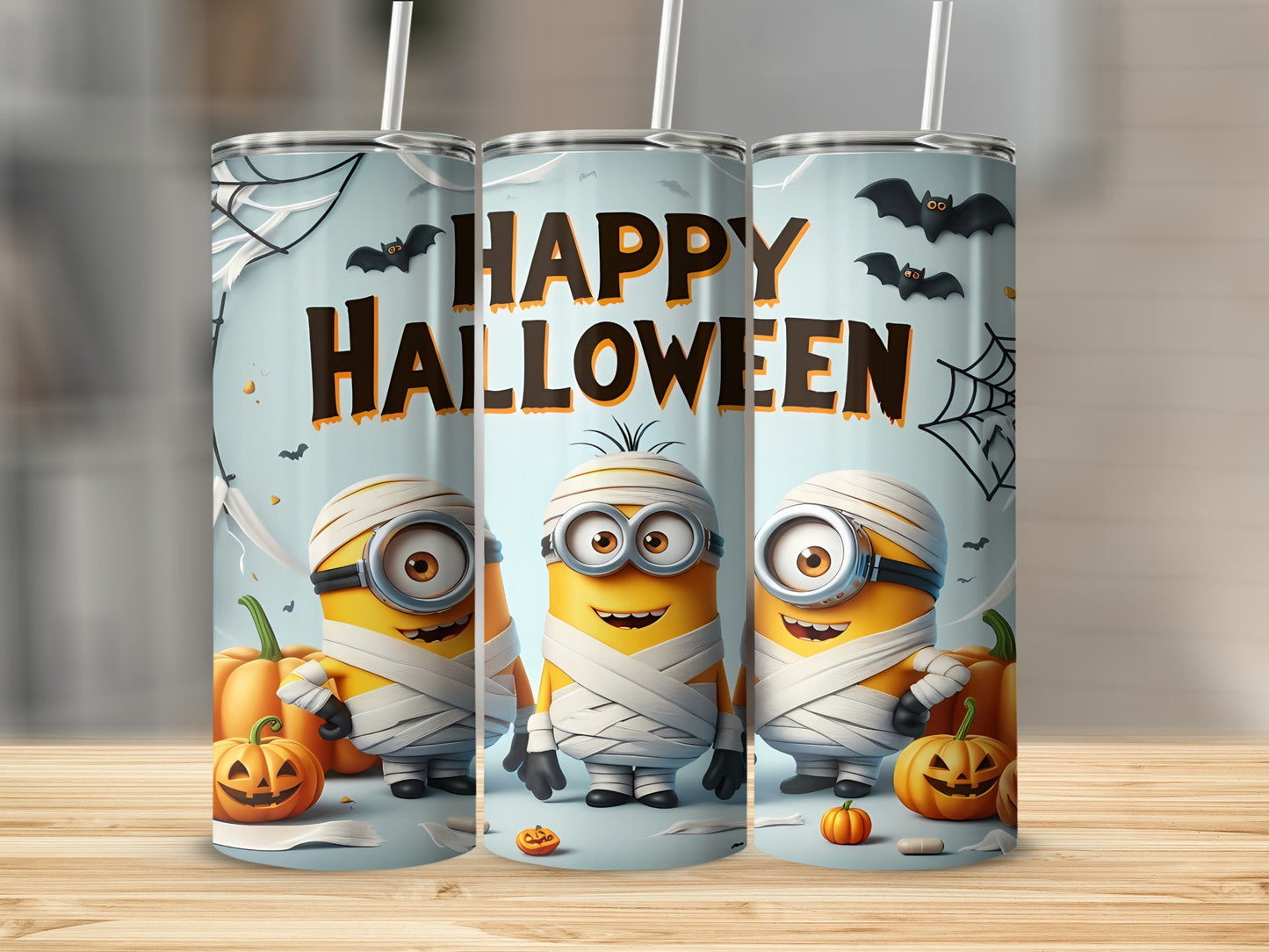 Three Minions dressed as mummies with pumpkins and bats saying "Happy Halloween."