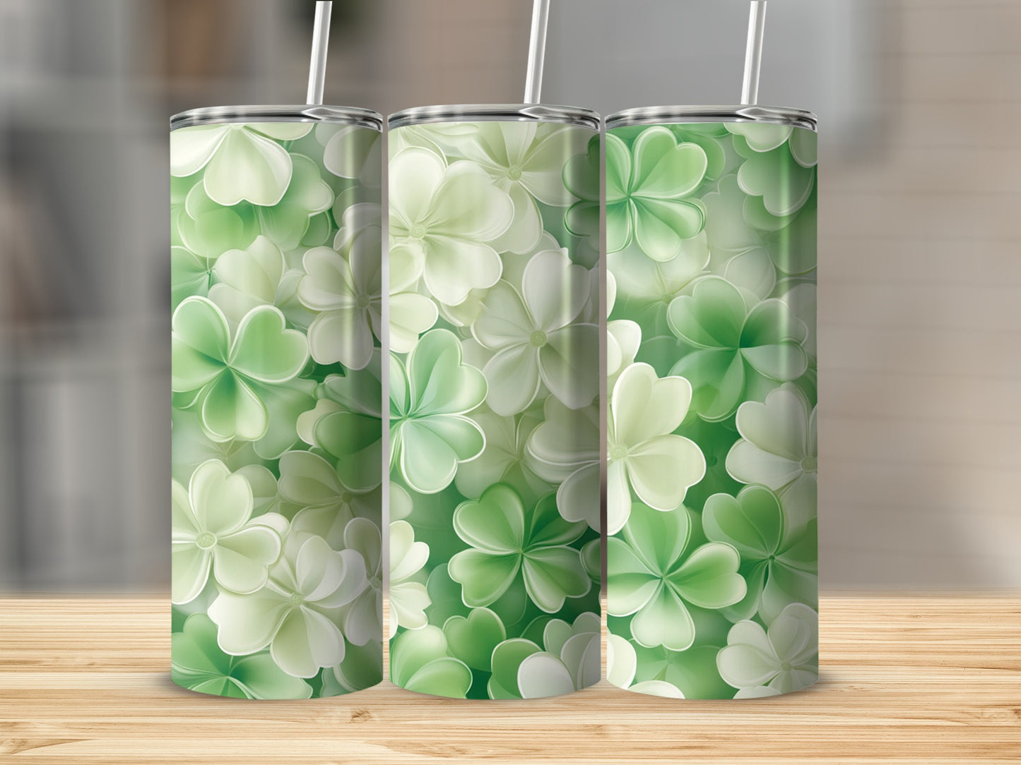 Three green shamrock tumblers with straws on a wooden surface.