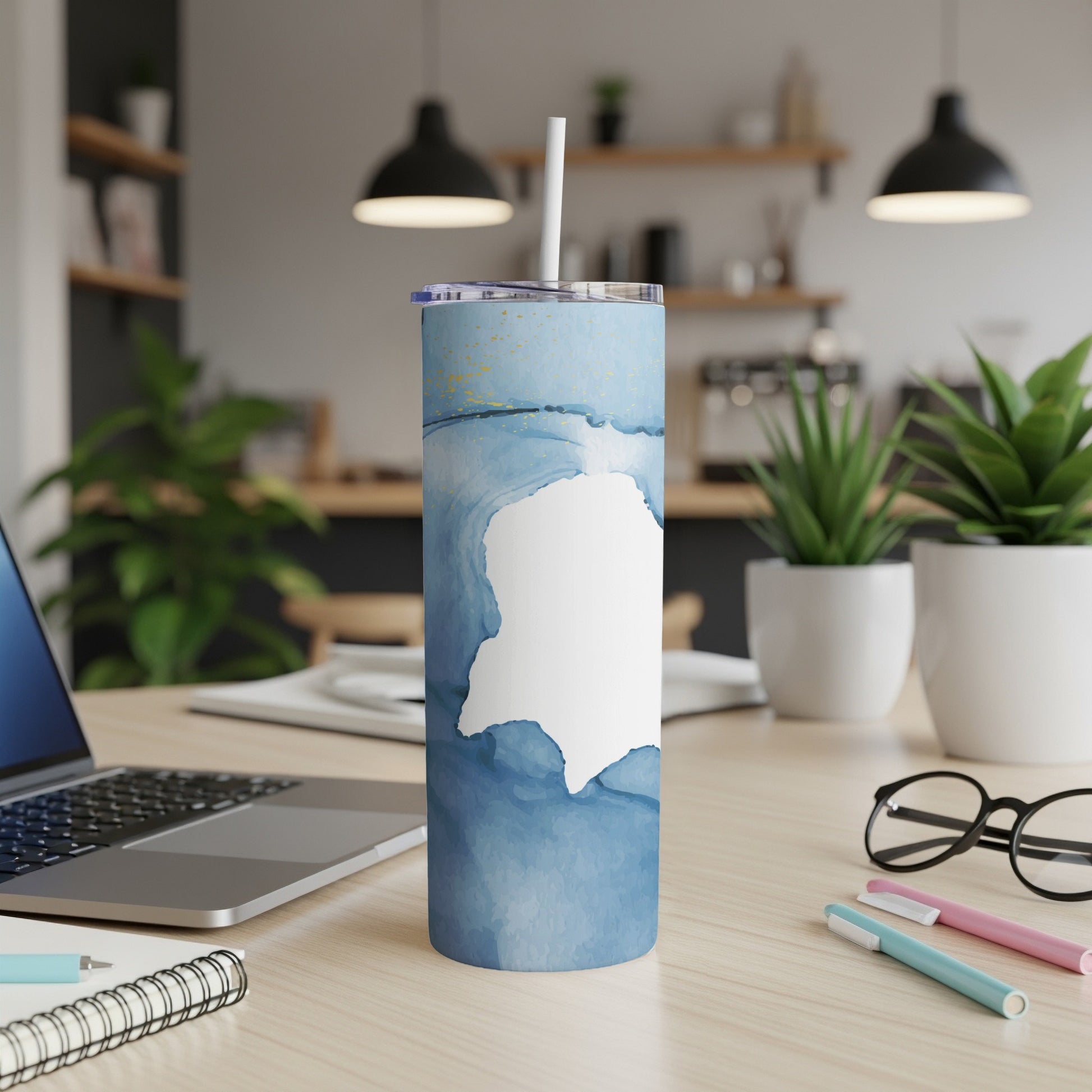 Blue watercolor abstract art tumbler with a white outline of a map.