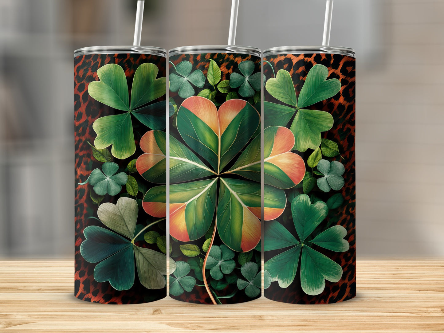 Three tumblers with a leopard print background and shamrock designs.