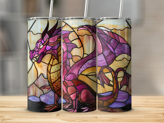 Three stained-glass dragon tumblers with straws on a wooden surface.