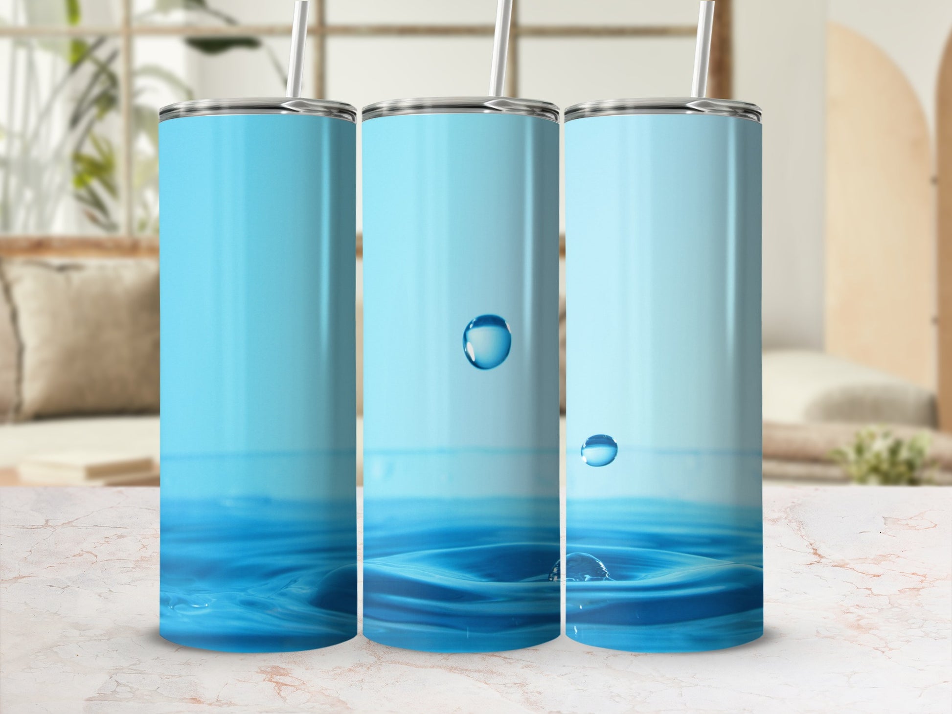 Three blue tumblers with water splash graphic and straws.