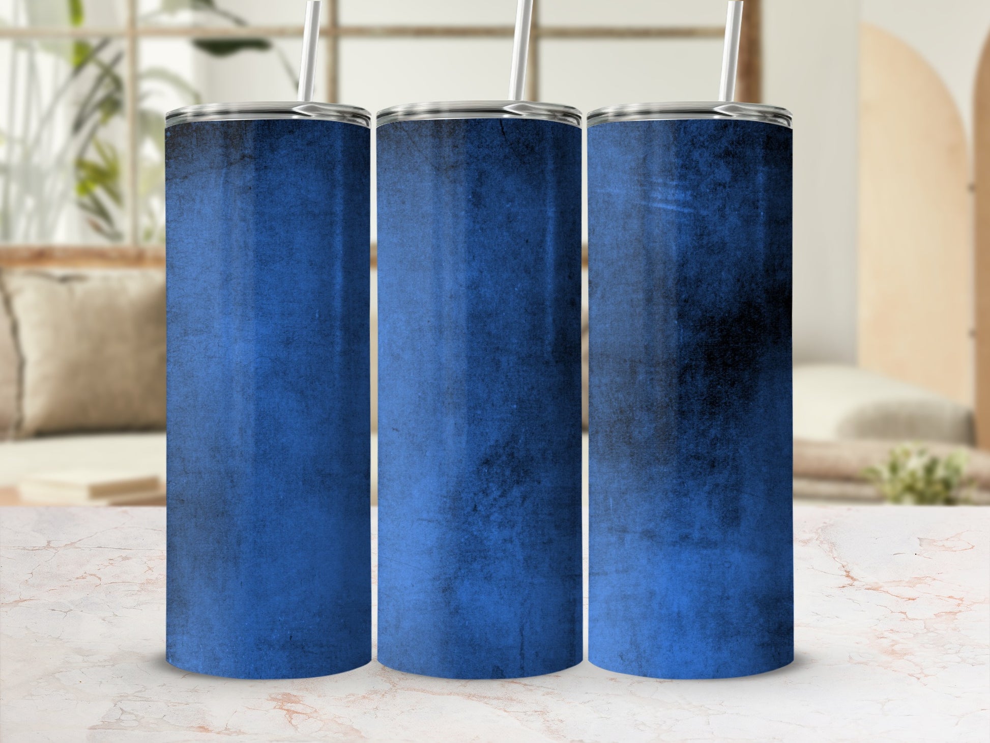 Three stainless steel tumblers with blue distressed texture and silver straws.