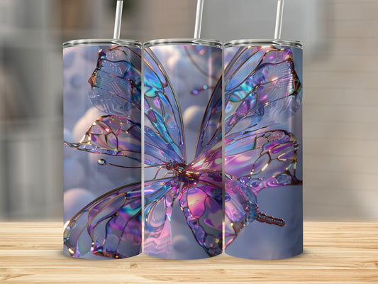 Iridescent butterfly tumbler with straw on a wooden surface.