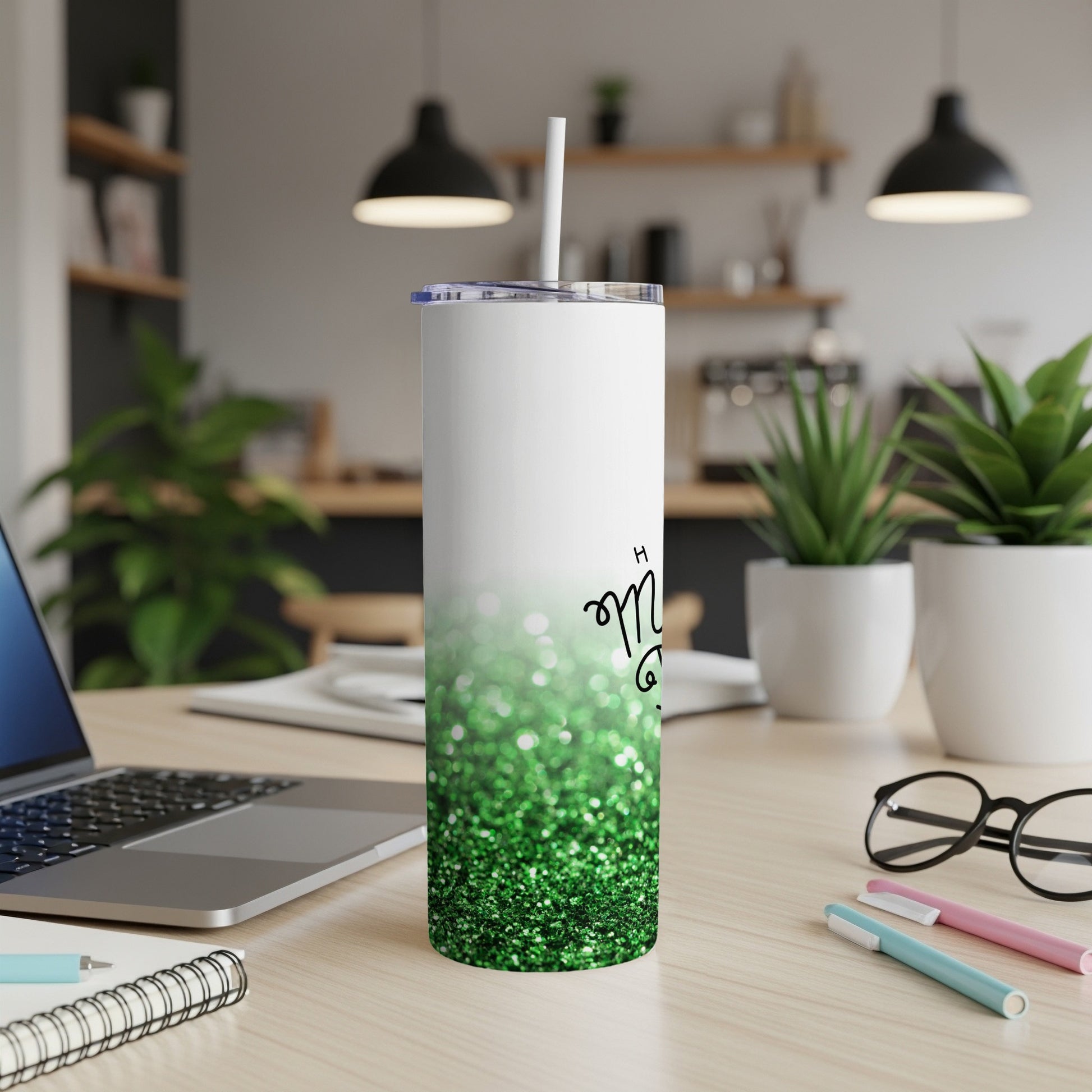 White tumbler with green glitter gradient, text partially visible.