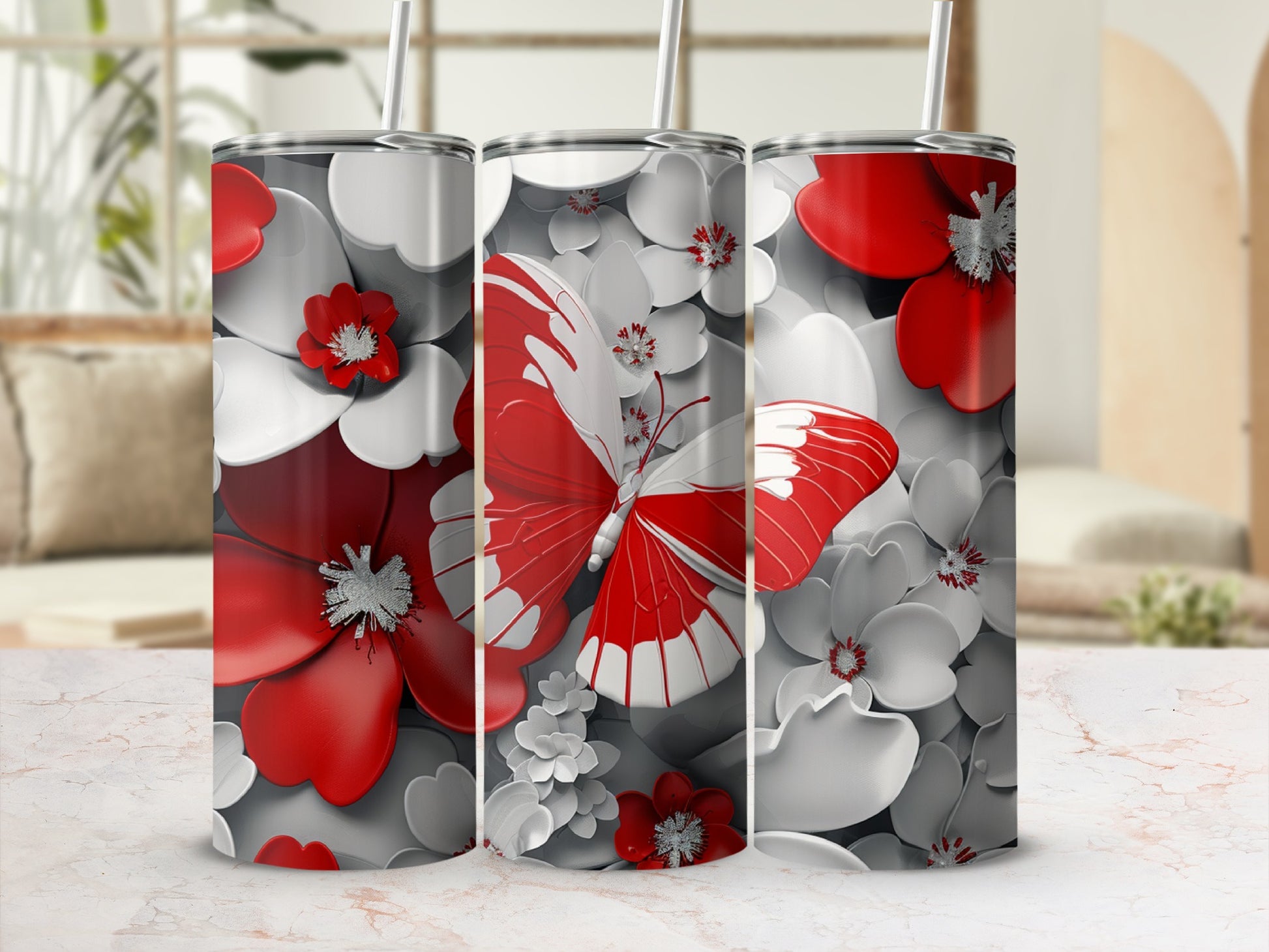 Three tumblers with red and white butterflies and floral designs.