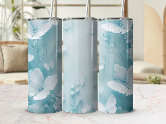 Three light blue tumblers with white floral and butterfly designs.