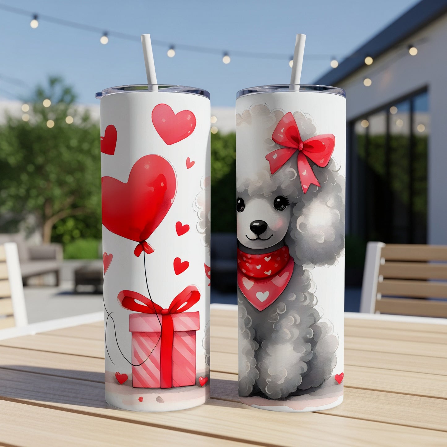 Two skinny tumblers with Valentine's Day graphics of a poodle and gift box.