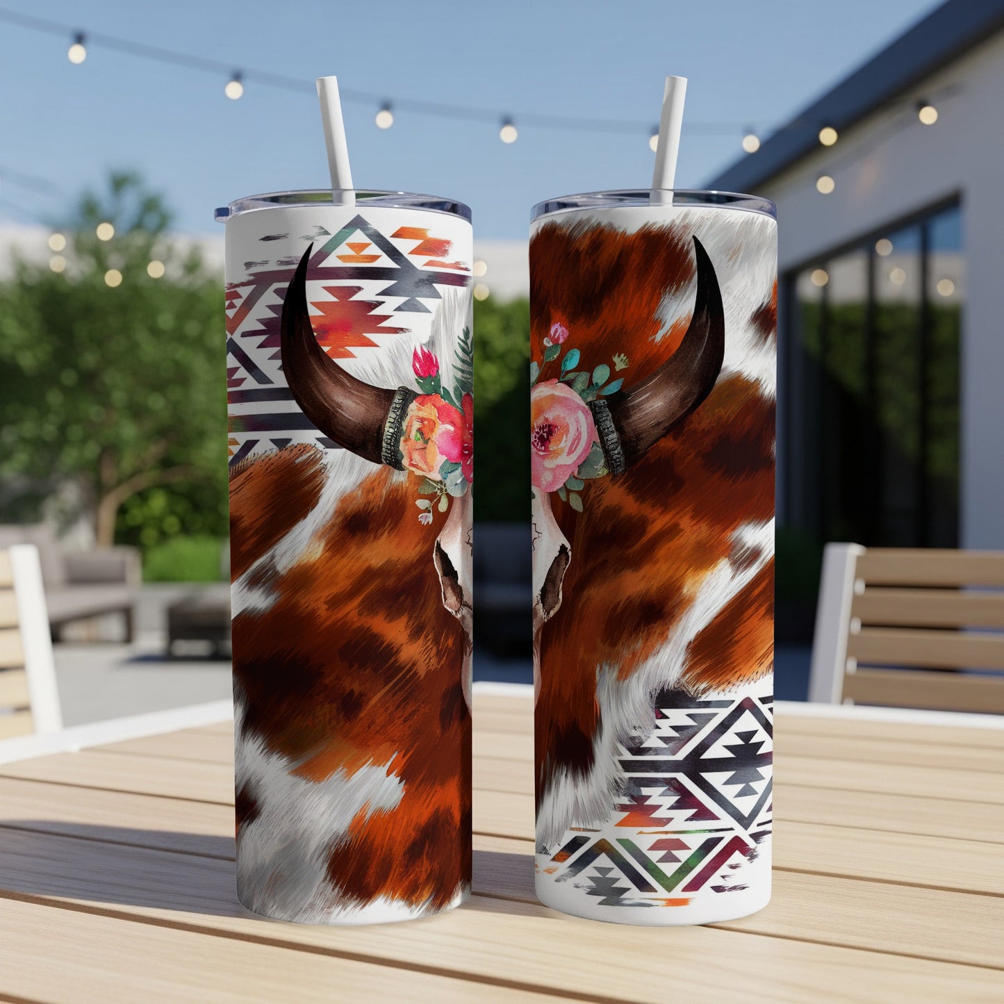 Cow skull tumbler with floral accents and geometric patterns.