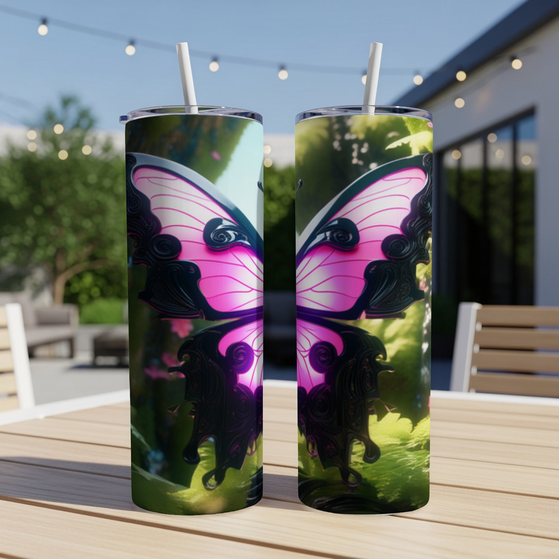 Two pink butterfly tumblers with straws on a wooden table outdoors.