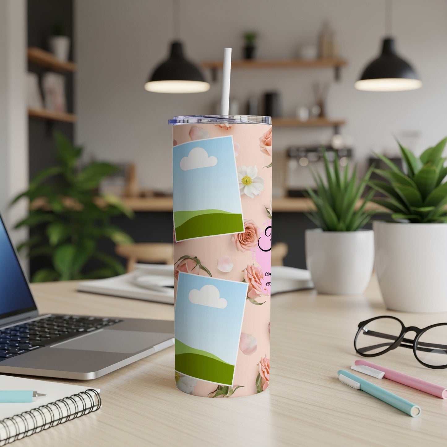 Pink tumbler with floral pattern, two photo frames, and straw.