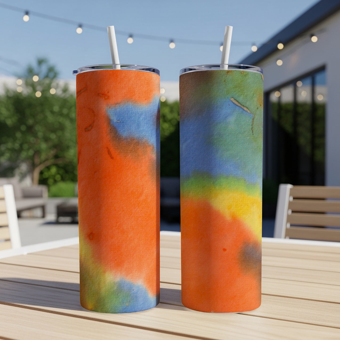 Two tumblers with abstract watercolor designs in orange, blue, and yellow.