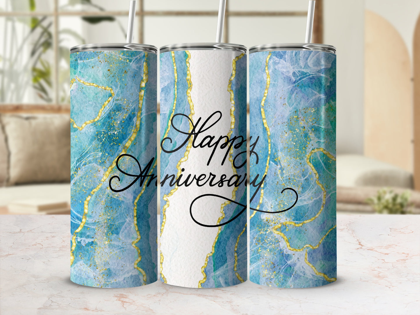 Three tumblers with a blue marble and gold splatter design, text reads "Happy Anniversary".
