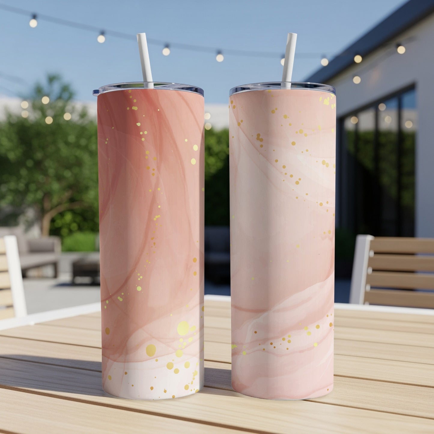 Two tall, skinny tumblers with a pink marble and gold glitter design.