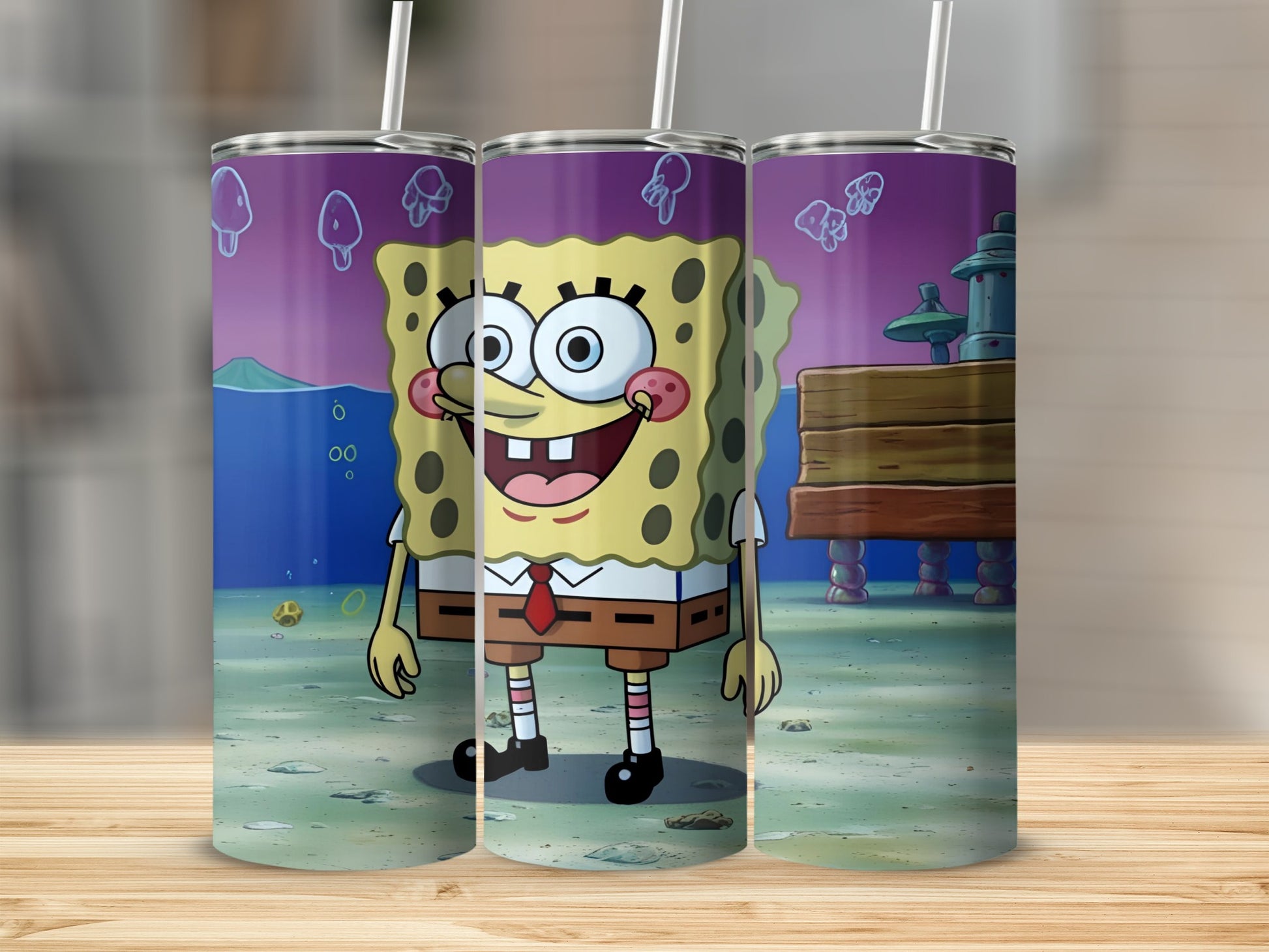 SpongeBob SquarePants tumbler with straw, standing on beach.