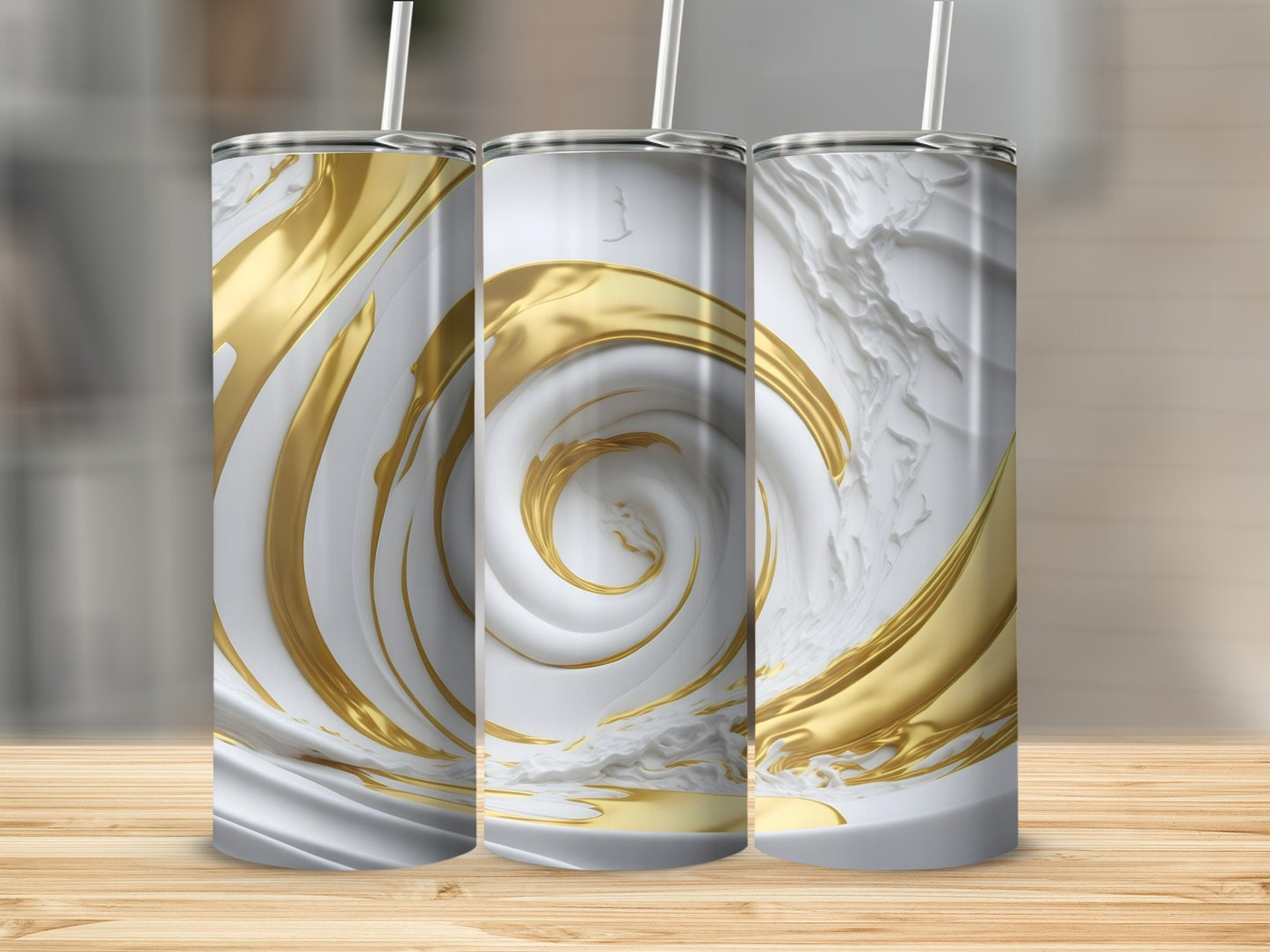 Three white and gold swirling tumblers on a wooden surface.