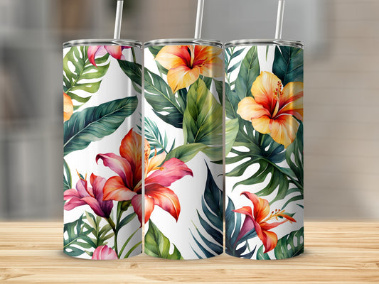Three tumblers with a tropical floral pattern on a wooden surface.