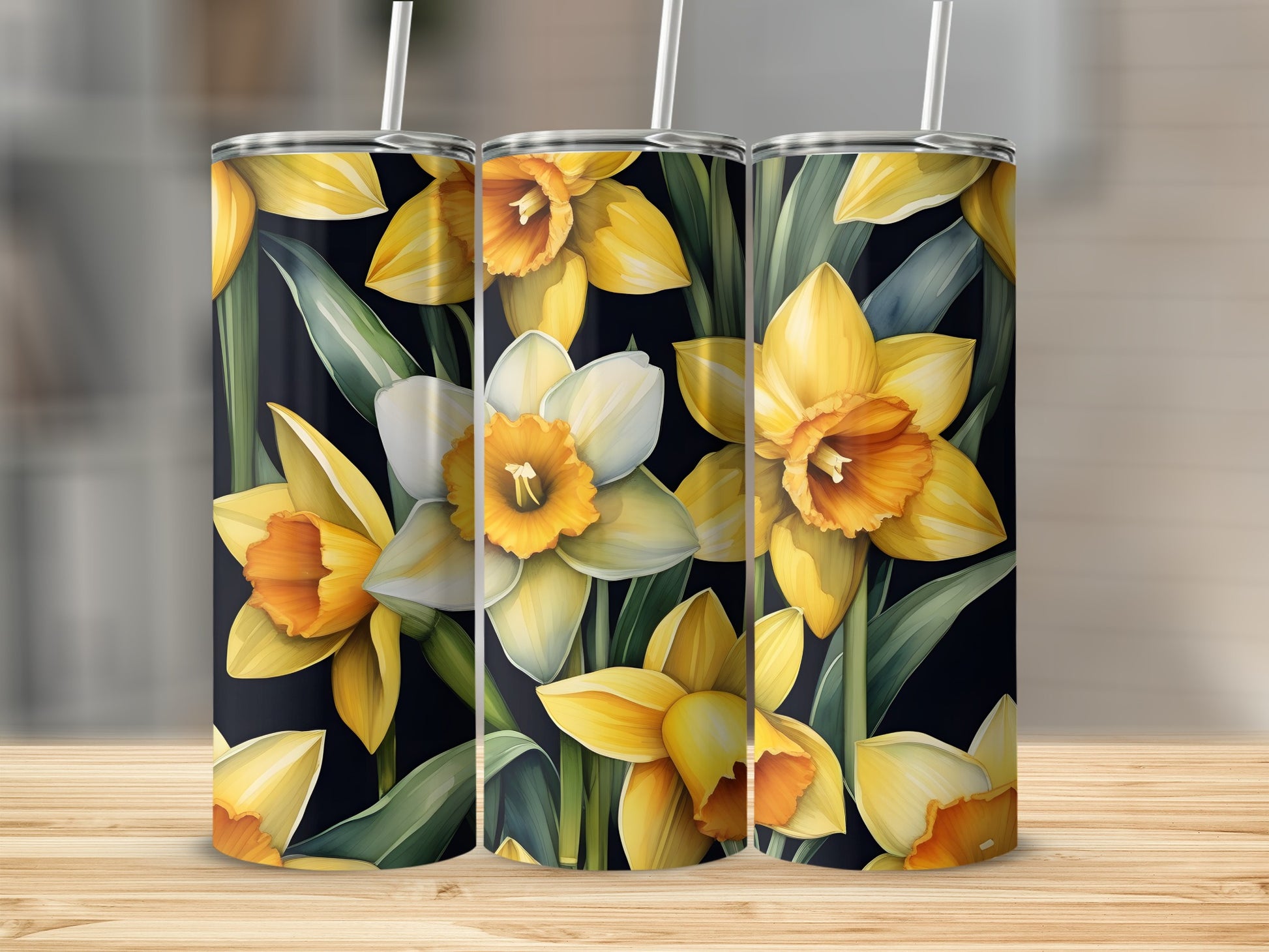 Three tumblers with a floral pattern of yellow and white daffodils.