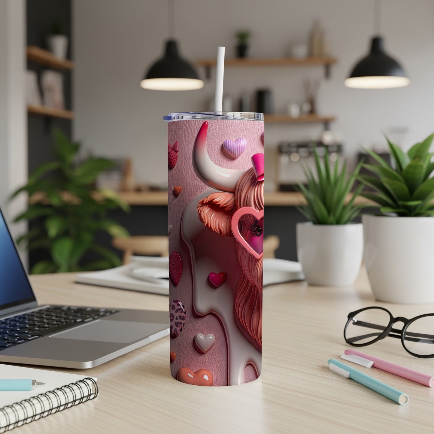 Pink insulated tumbler with cow heart design and straw.