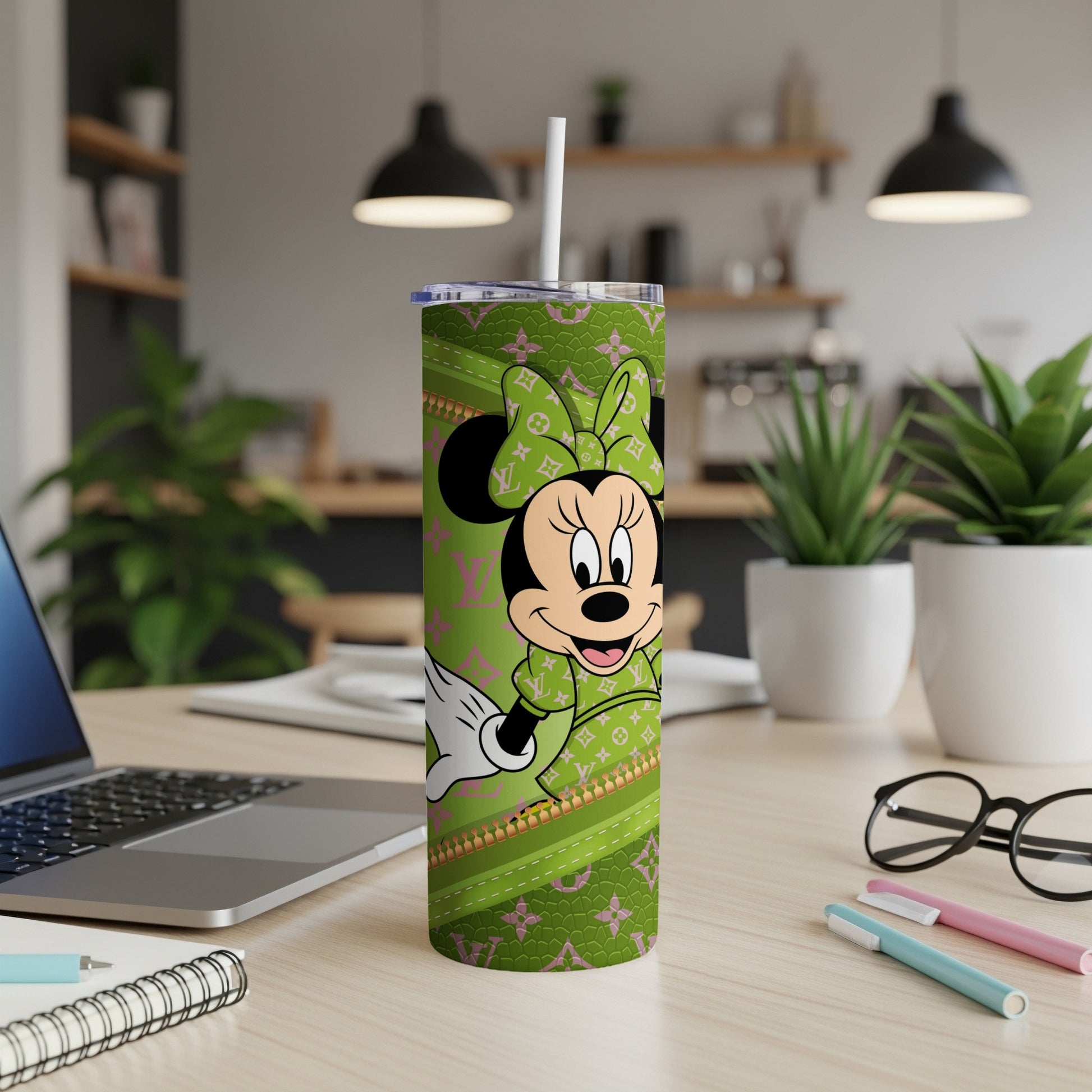 Minnie Mouse on a green patterned tumbler with a white straw.