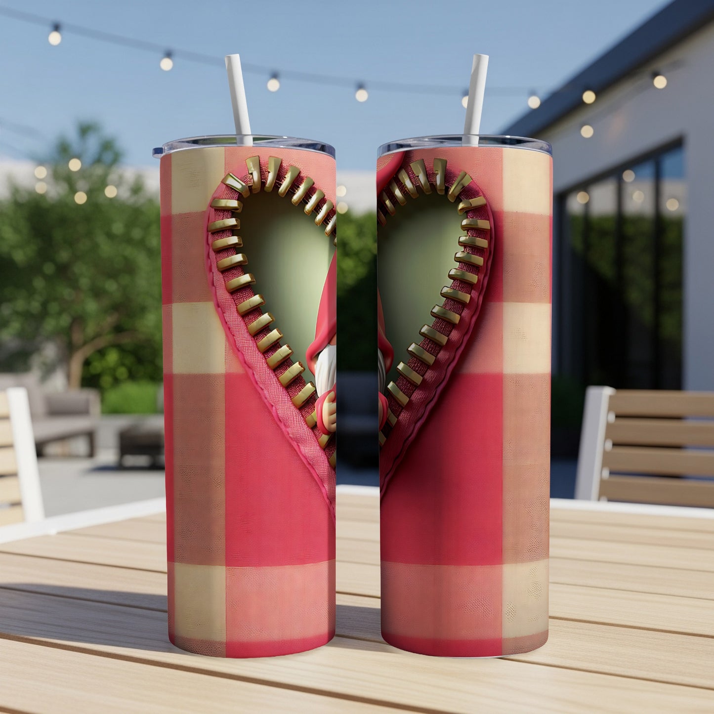 Two tumblers with a Valentine's Day gnome heart design on a picnic table.