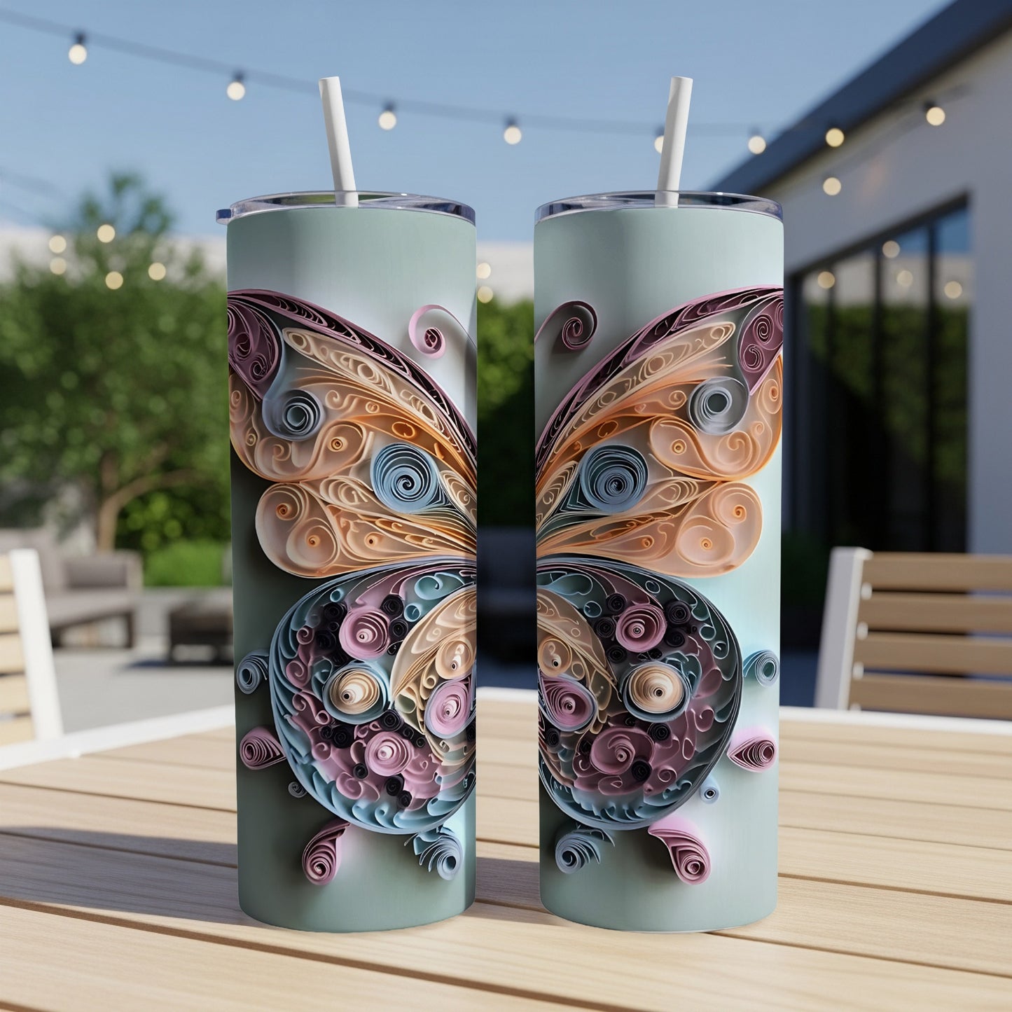 Two tumblers with pastel butterfly designs, each topped with a straw.