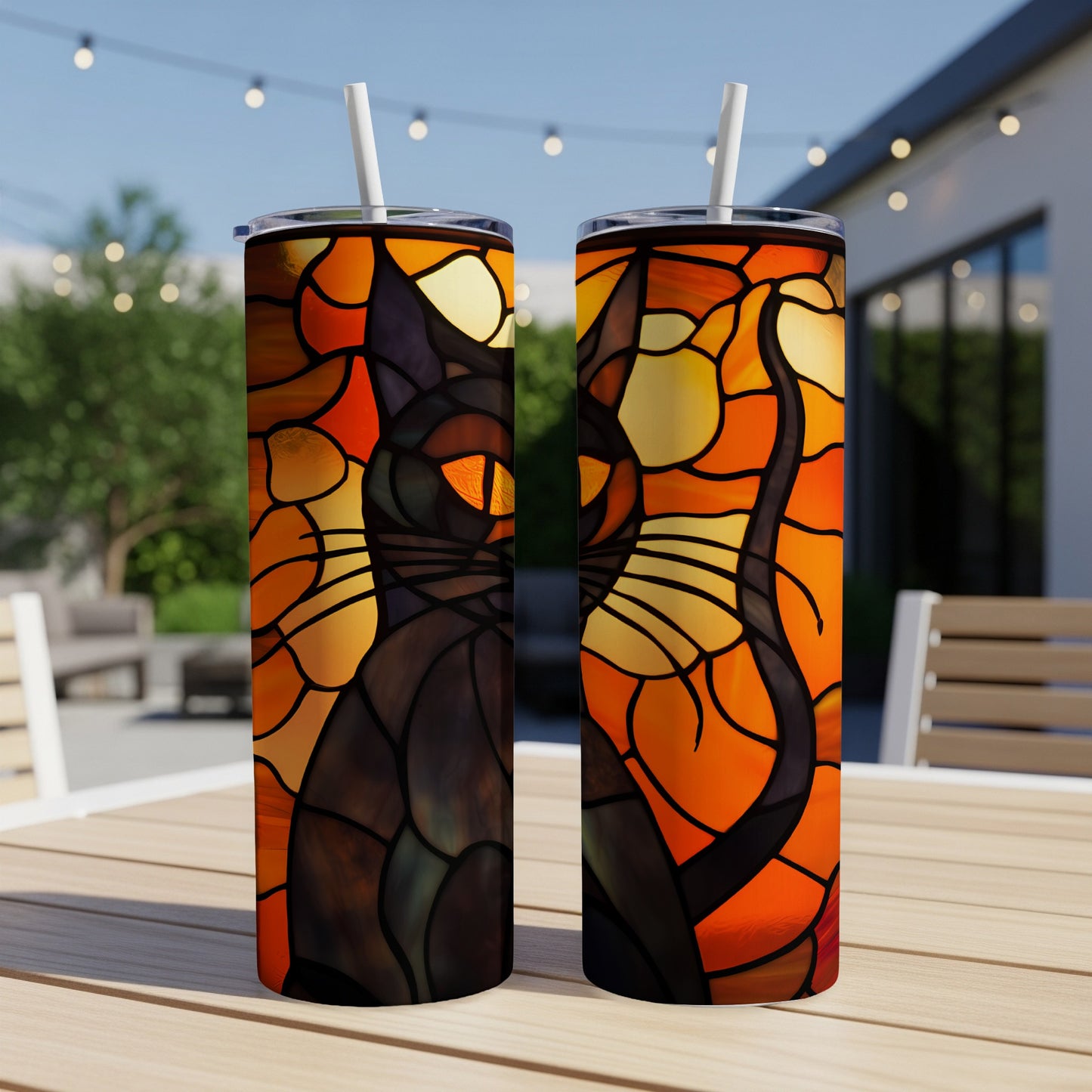 Stained glass black cat design on two skinny tumblers on a wooden table.