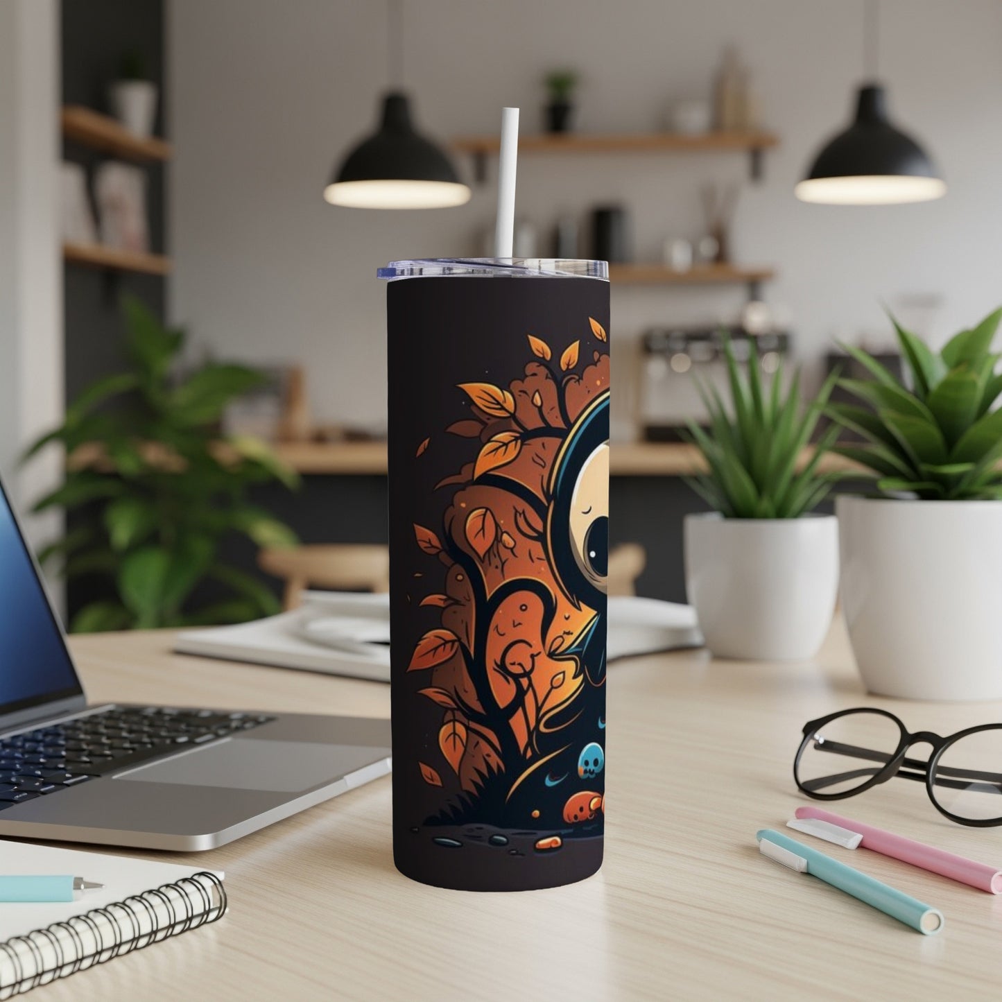 Black tumbler with cartoon spooky character and autumn leaves design.