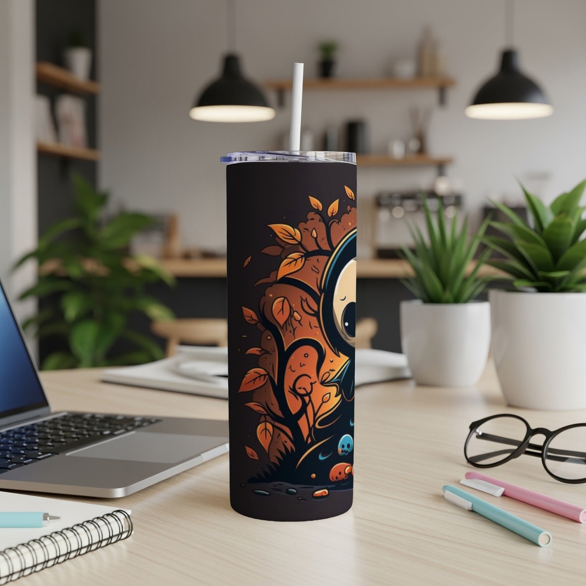 Black tumbler with cartoon spooky character and autumn leaves design.