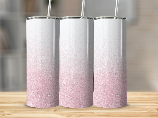 Three white tumblers with pink glitter gradient and straws.