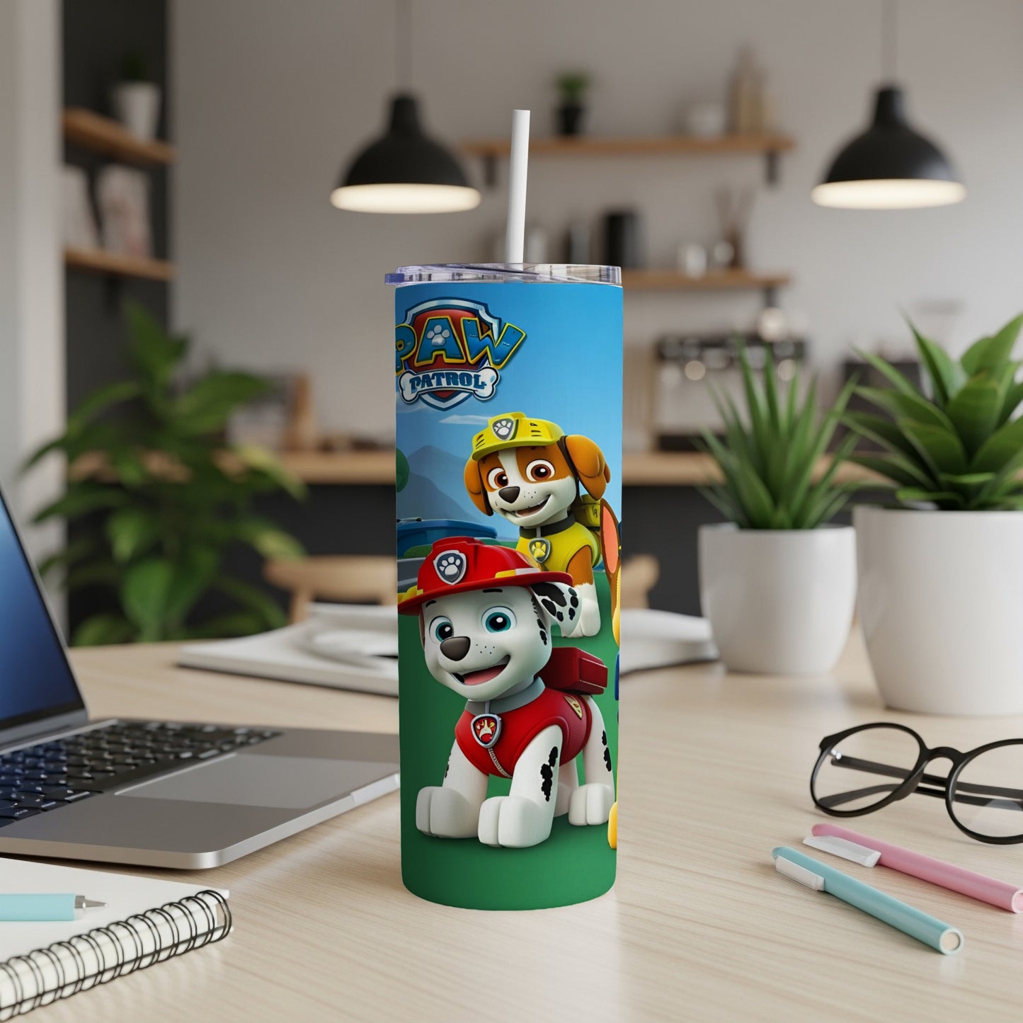 Paw Patrol characters Marshall and Chase on a blue tumbler with white straw.