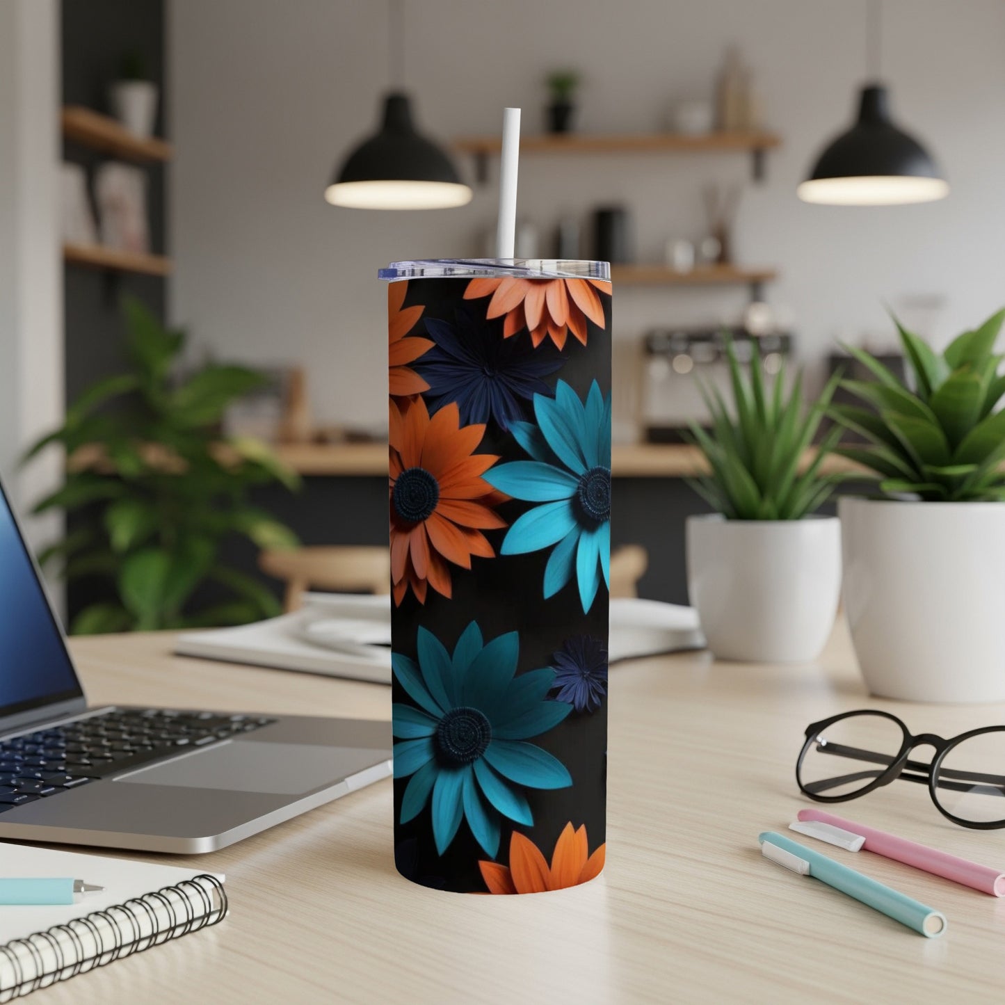 Tall tumbler with orange and teal floral pattern on black background.