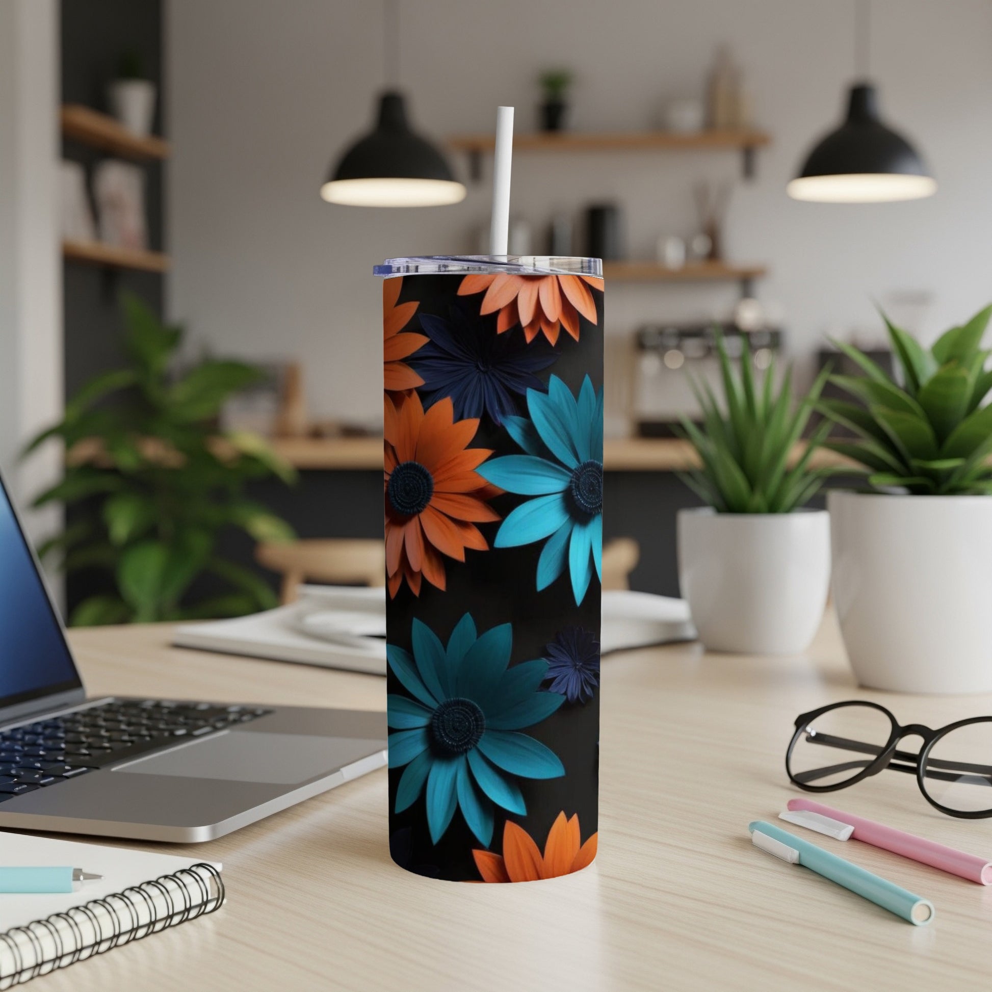 Tall tumbler with orange and teal floral pattern on black background.
