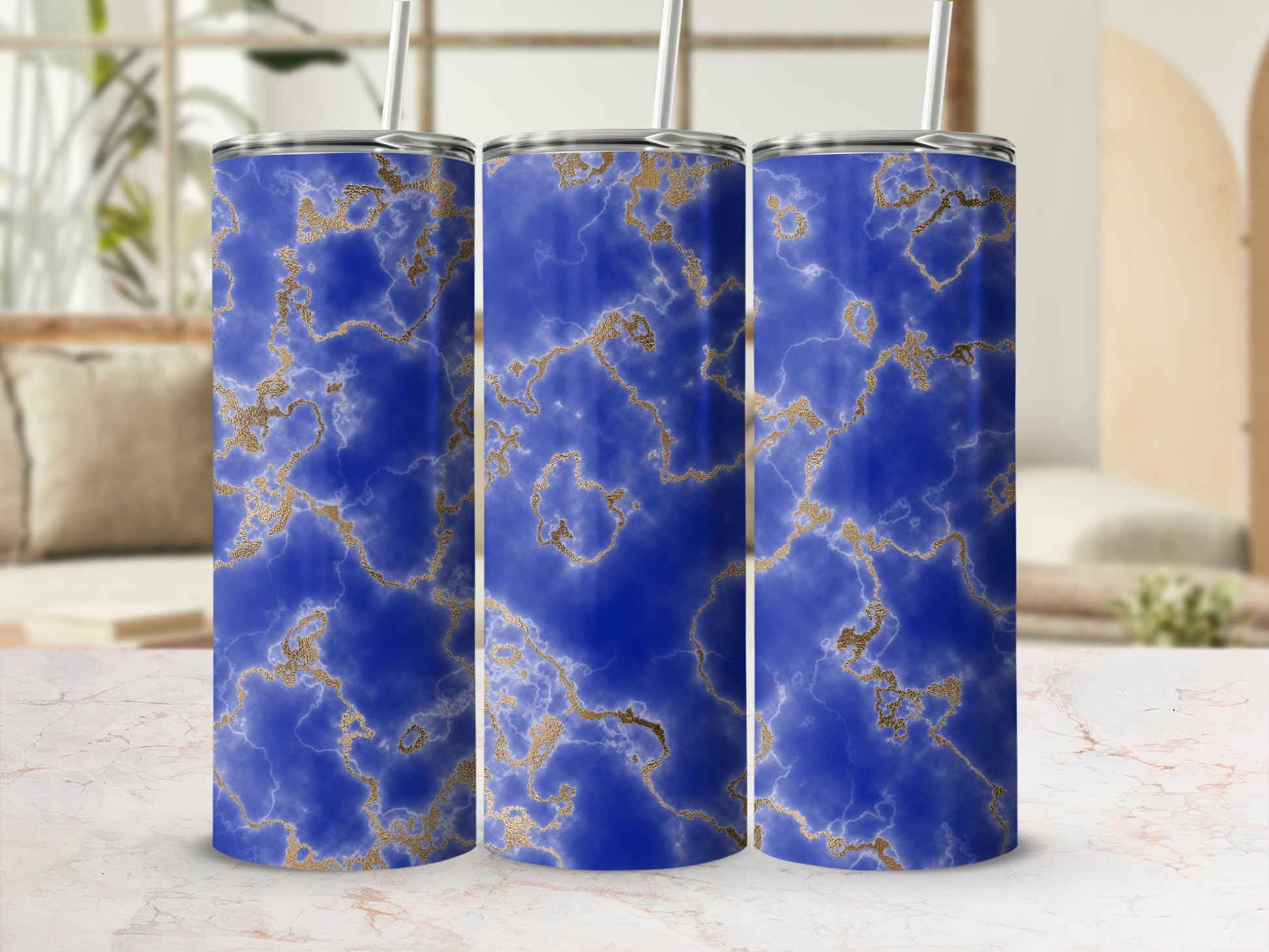 Three blue marble tumblers with gold veining.