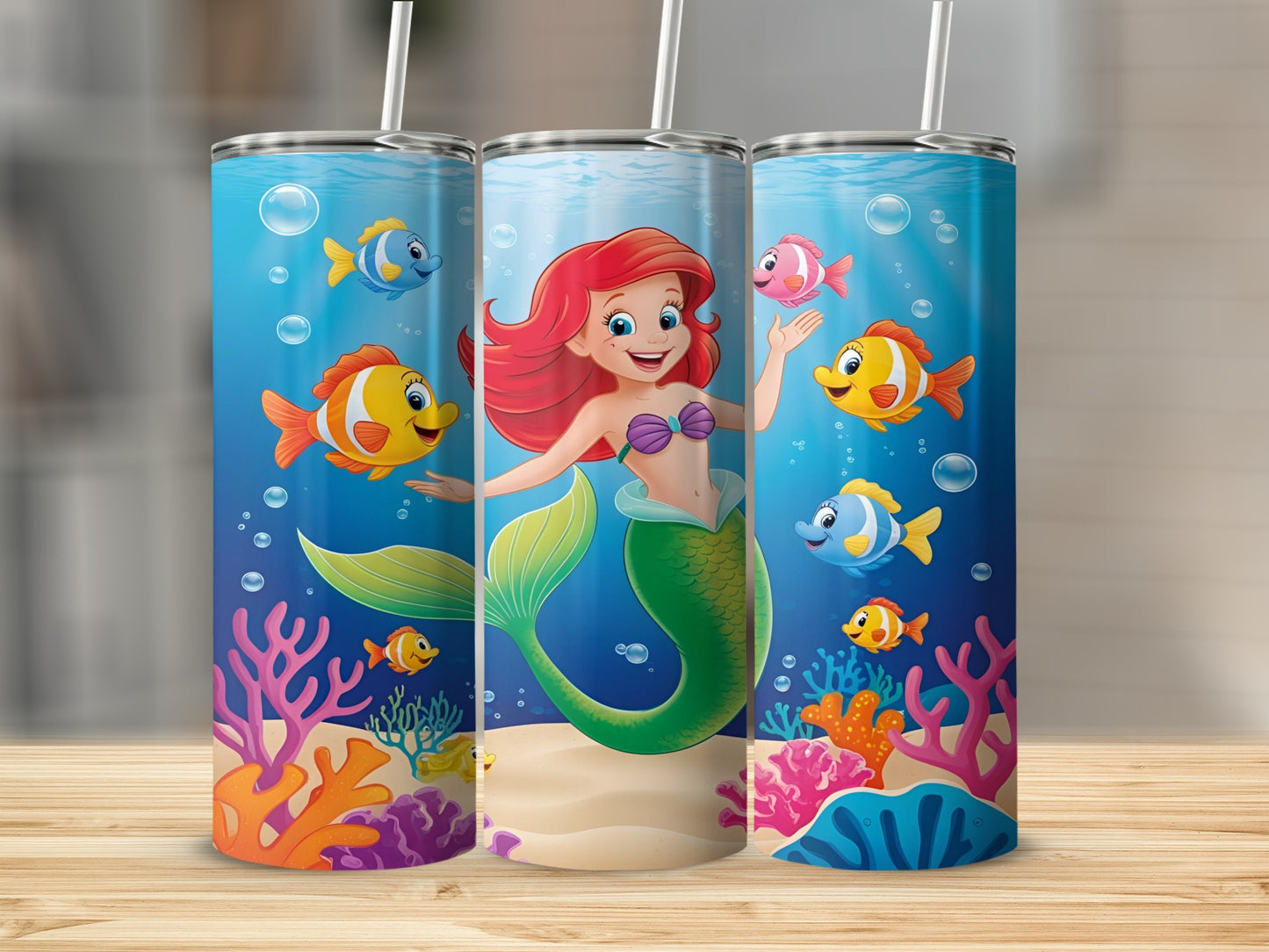 Ariel and friends swim in colorful underwater scene on three tumblers.