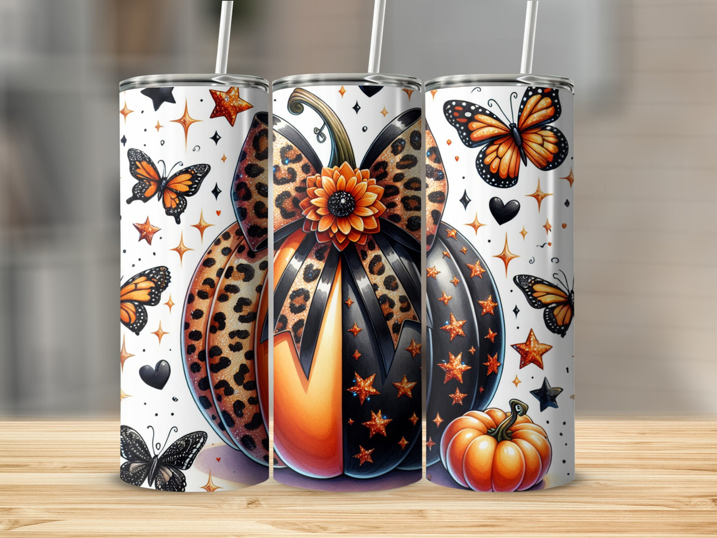 Three tumblers with pumpkin, butterfly, and star designs.
