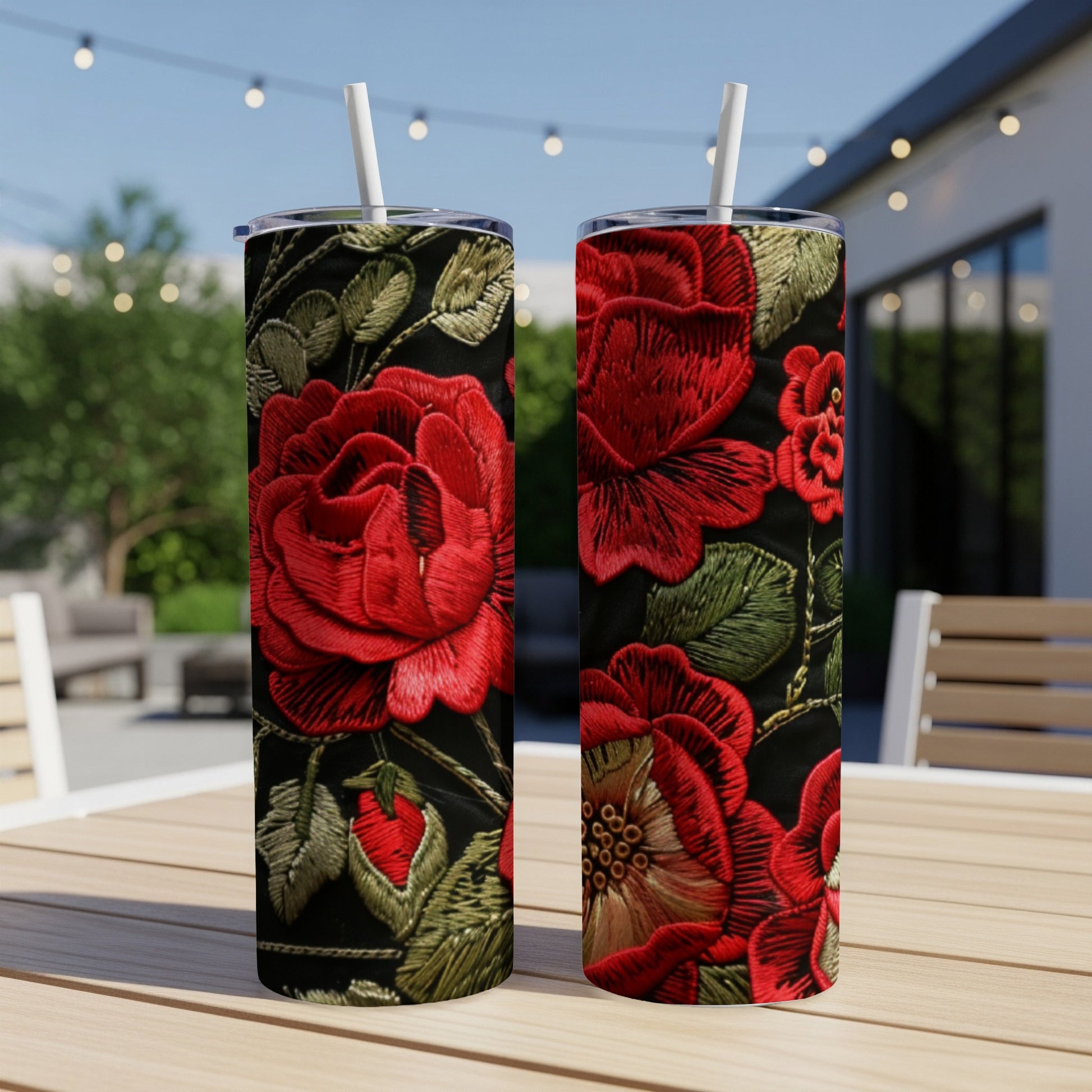 Two tall tumblers with a black background and embroidered red roses design.
