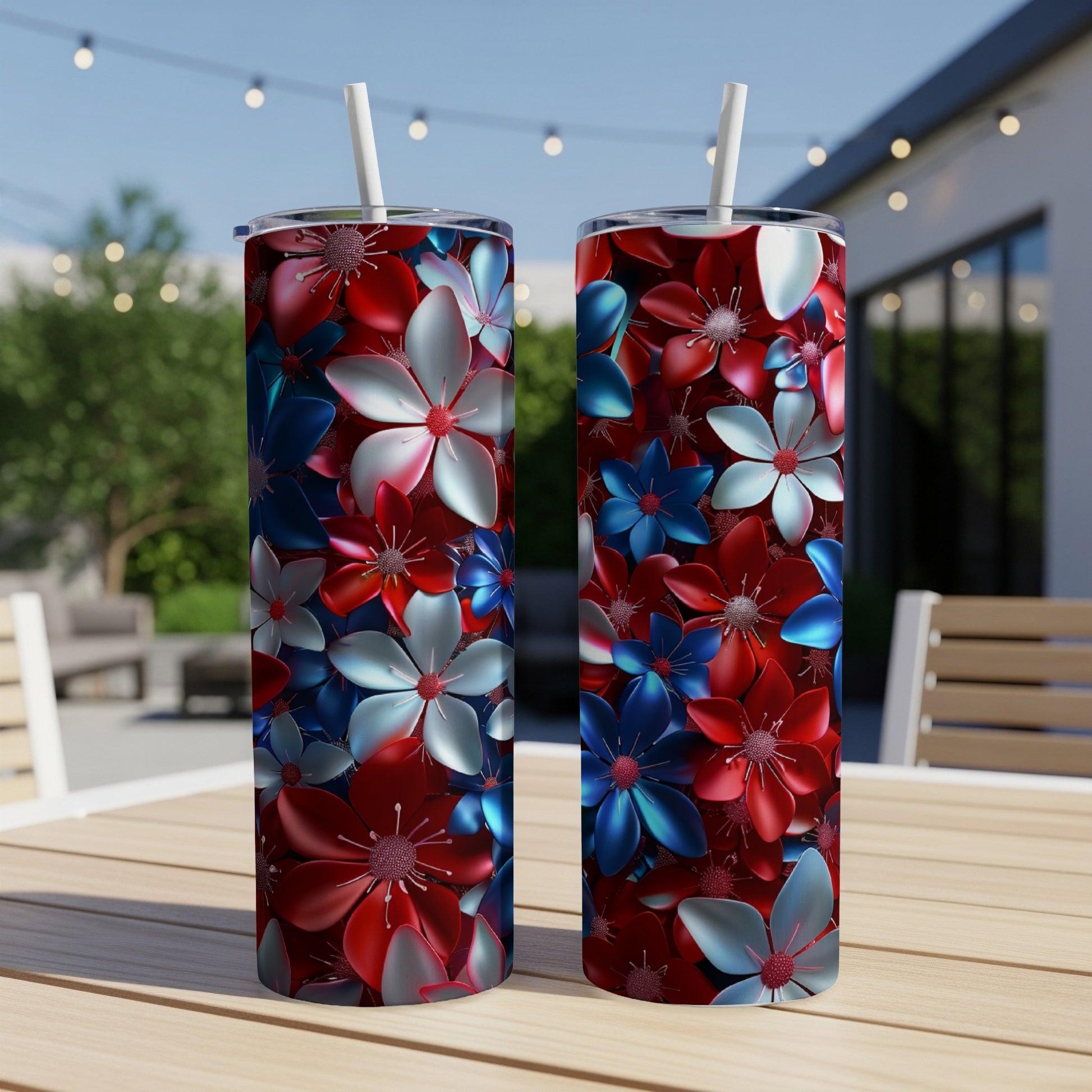 Two tumblers with red, white, and blue floral pattern on a patio table.