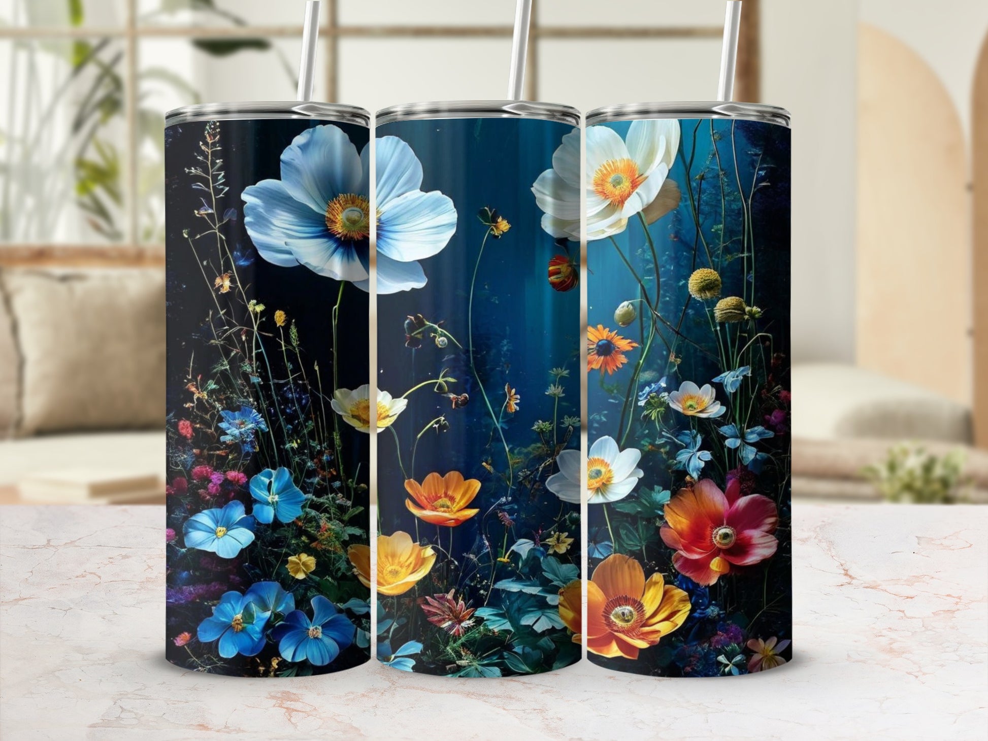 Three tumblers featuring vibrant floral designs on a dark background.