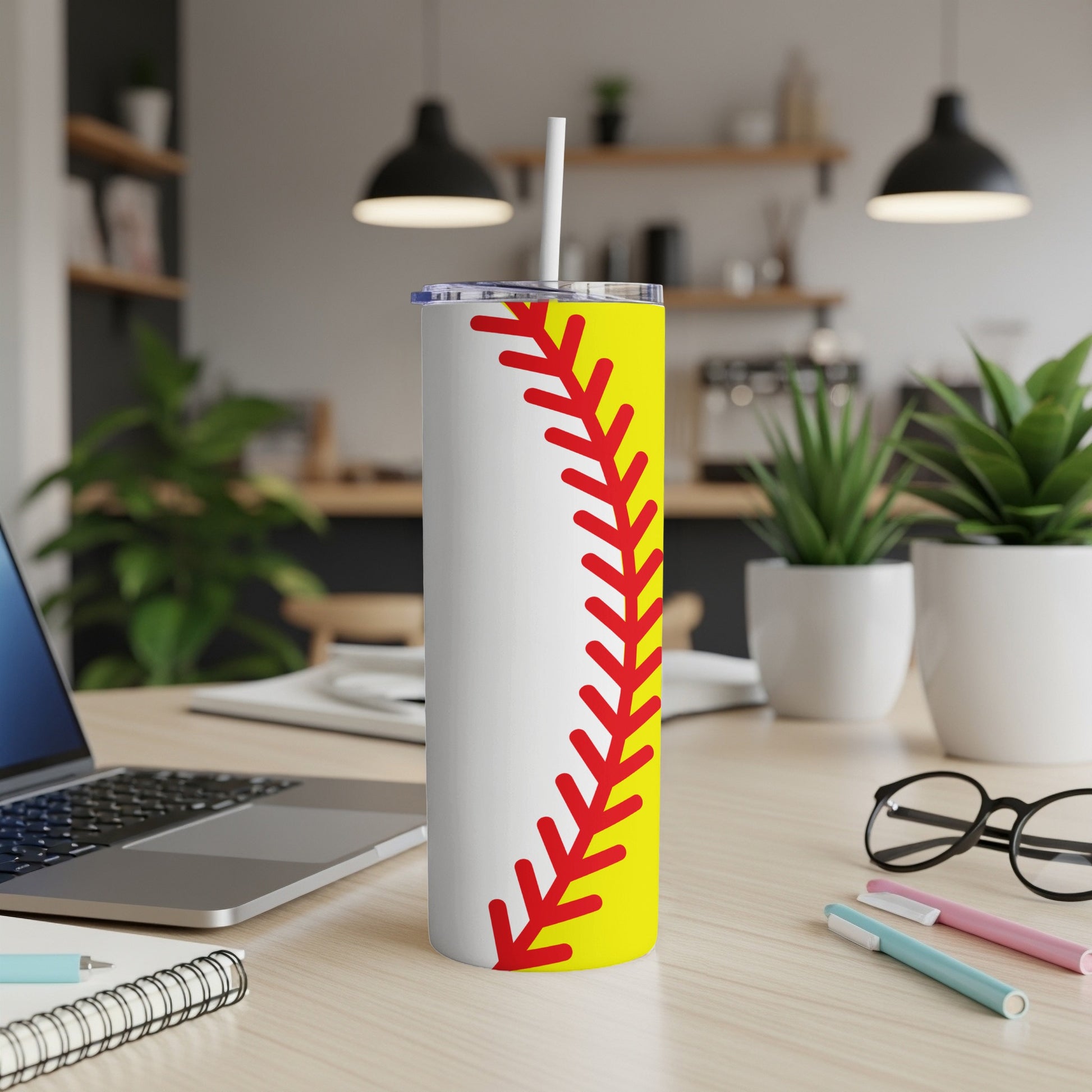 Yellow and red softball seam design on a white tumbler with straw.
