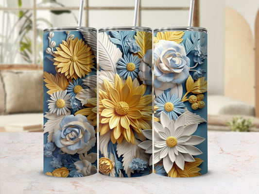 Blue tumbler with embossed yellow and white flowers and leaves.