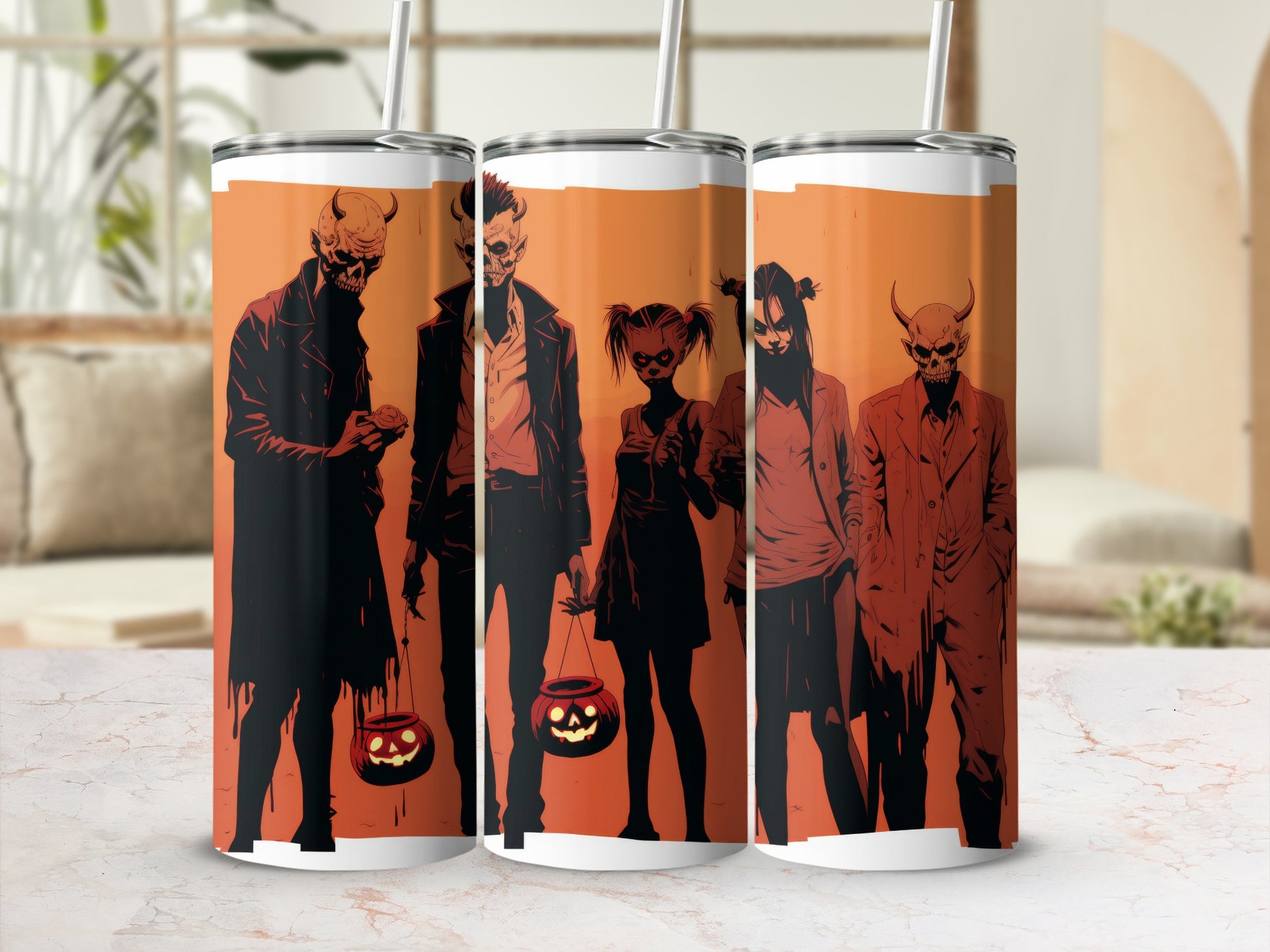 Tumbler with a Halloween design of demonic figures and jack-o'-lanterns.