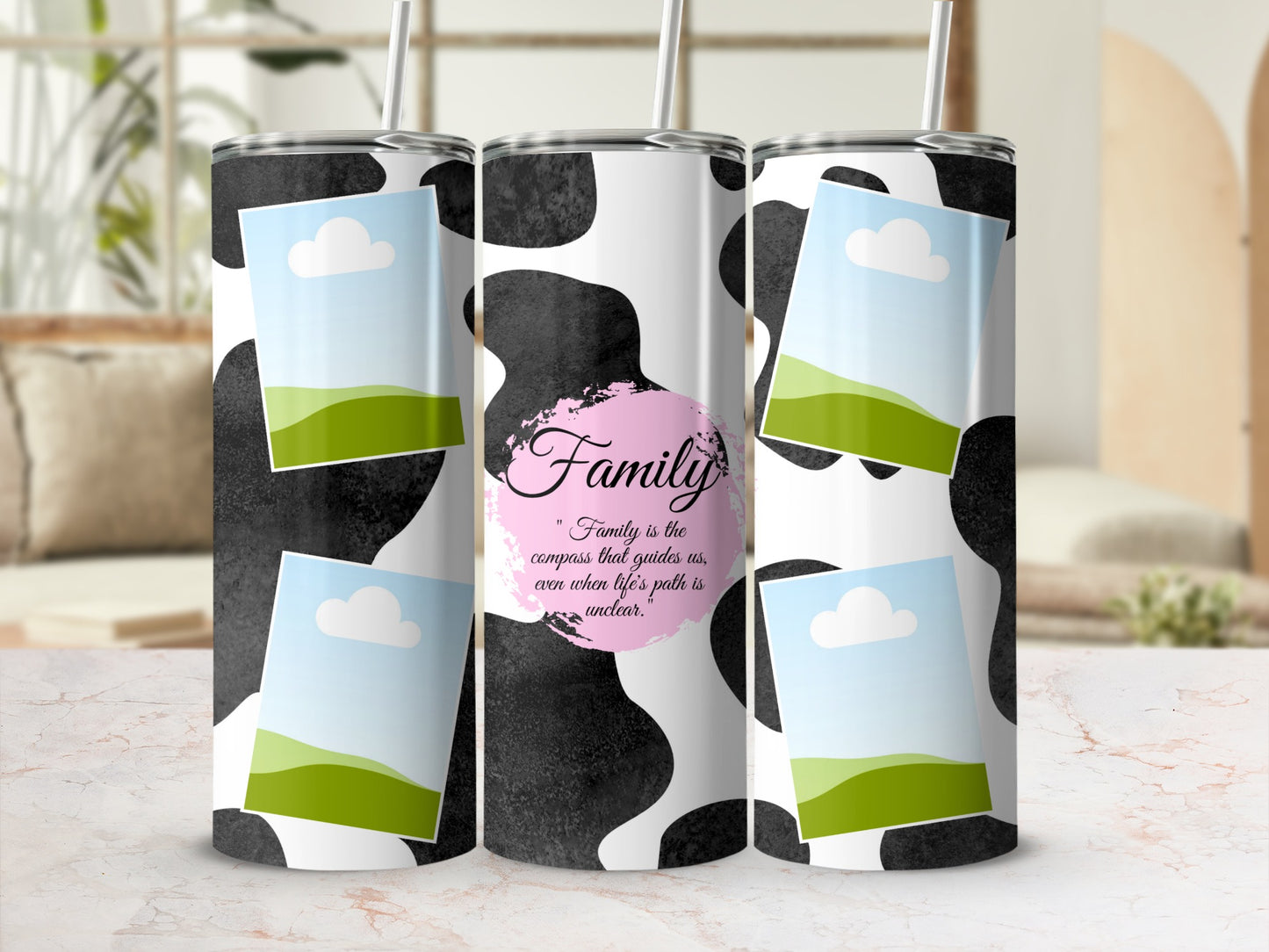 Tumblers with cow print, framed landscape photos, and the quote "Family is the compass."