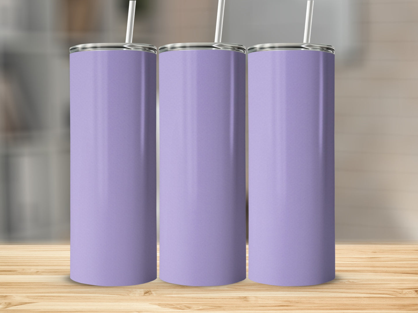 Three tall purple tumblers with white straws on a wooden surface.