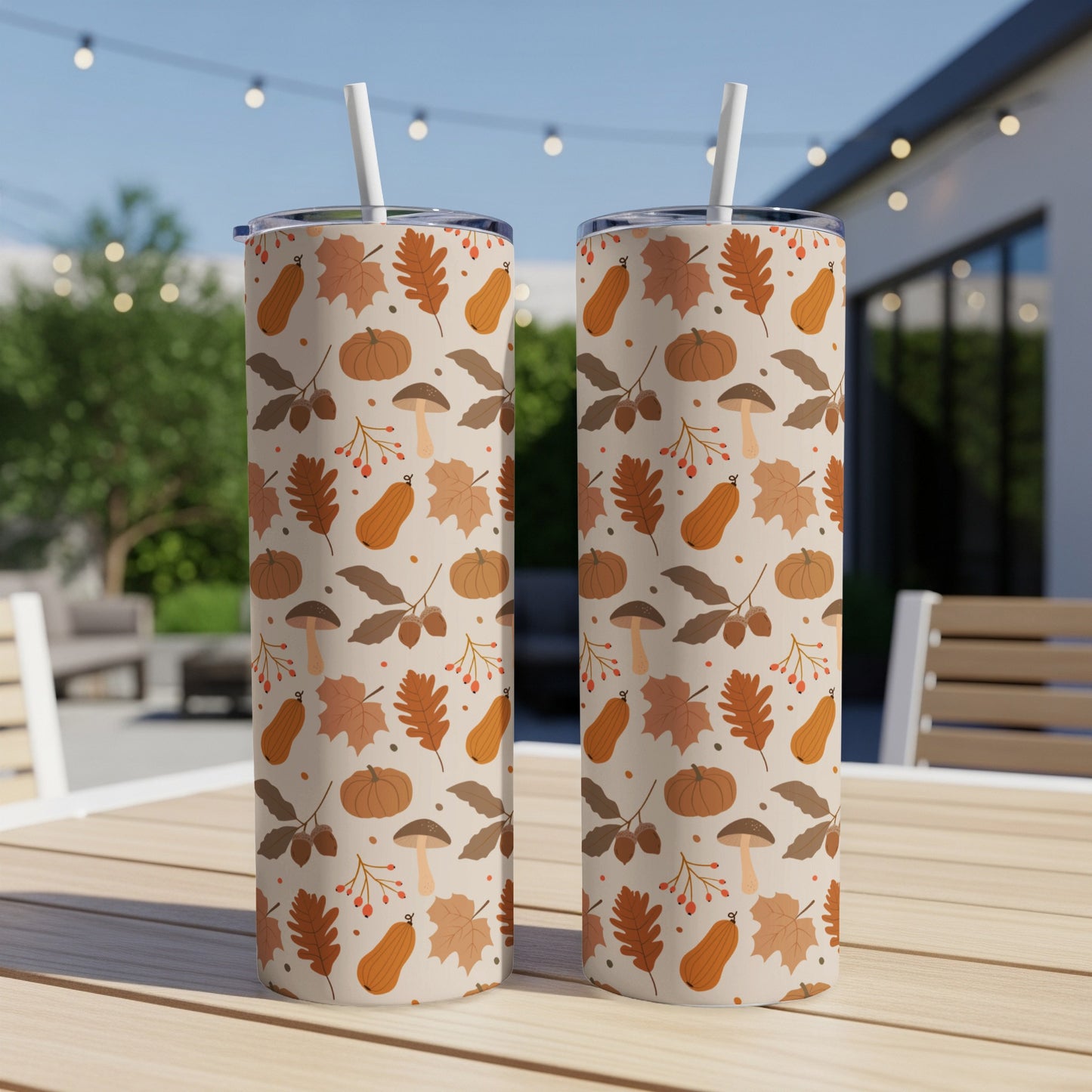 Two tumblers with a repeating pattern of autumn leaves, pumpkins, and mushrooms.