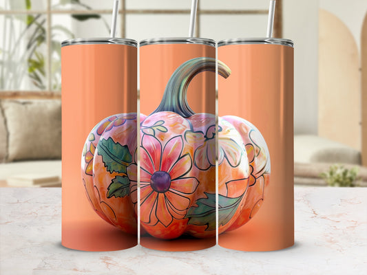 Orange tumbler with floral pumpkin design and straw.